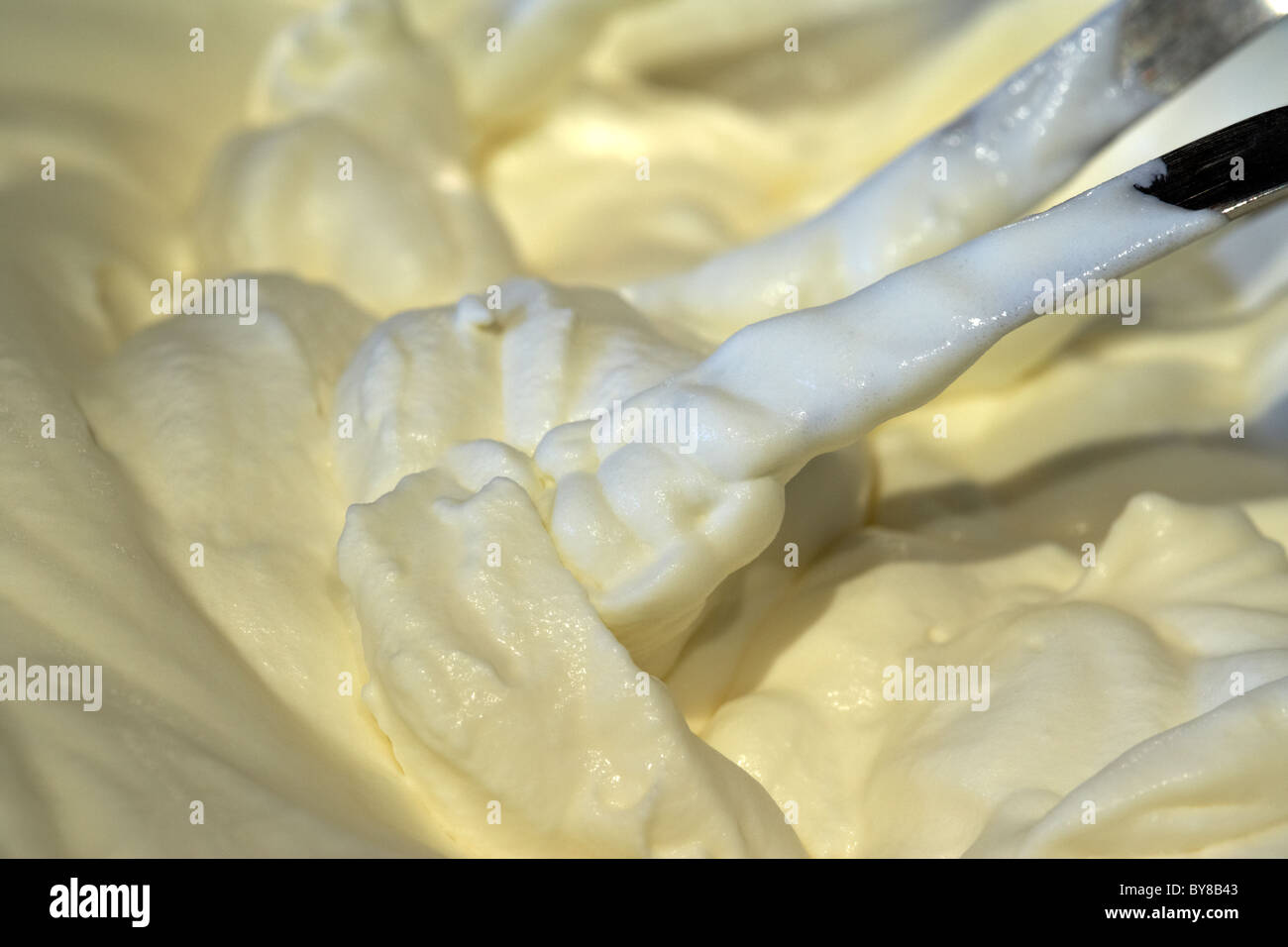 fresh whipping cream whipped up by an electric mixer Stock Photo Alamy