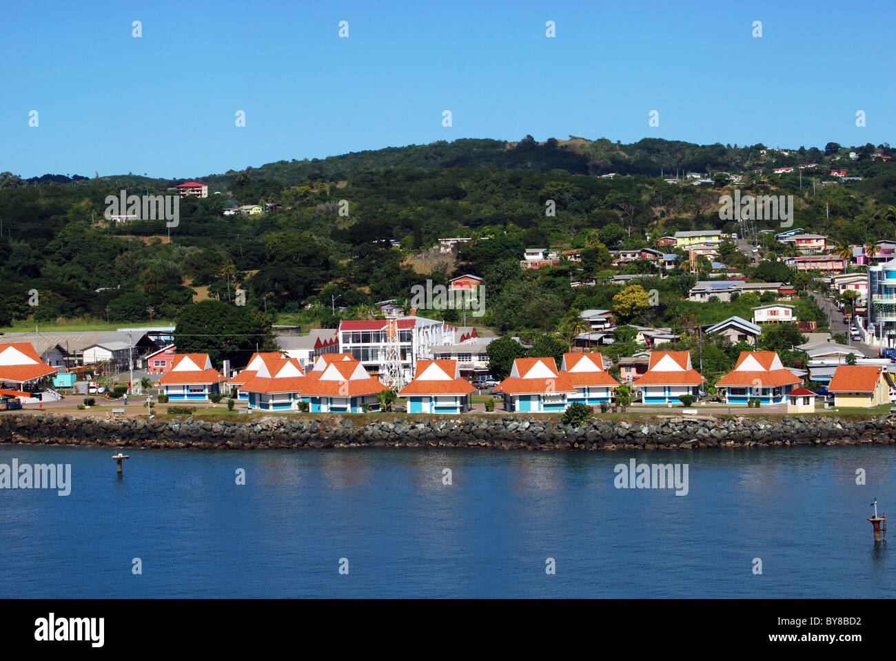 Waterside chalets with town to rear, Scarborough, Tobago, Trinidad and Tobago, Caribbean. Stock Photo