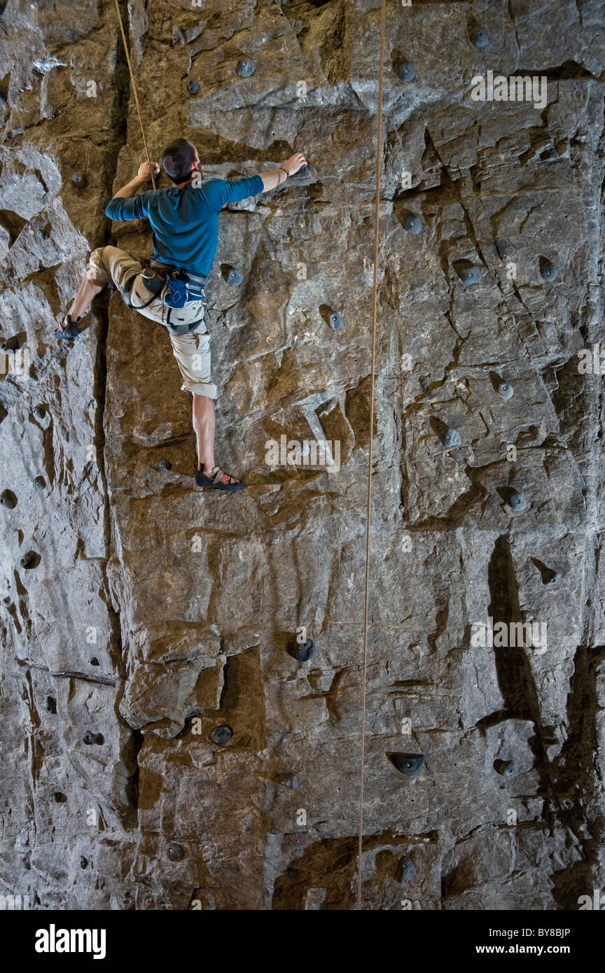 Man Climbing Rock Wall Stock Photo