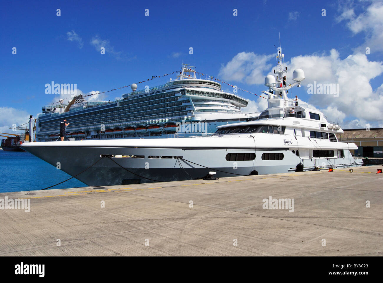 Yacht with cruise liner to rear, Bridgetown, Barbados, Caribbean. Stock Photo