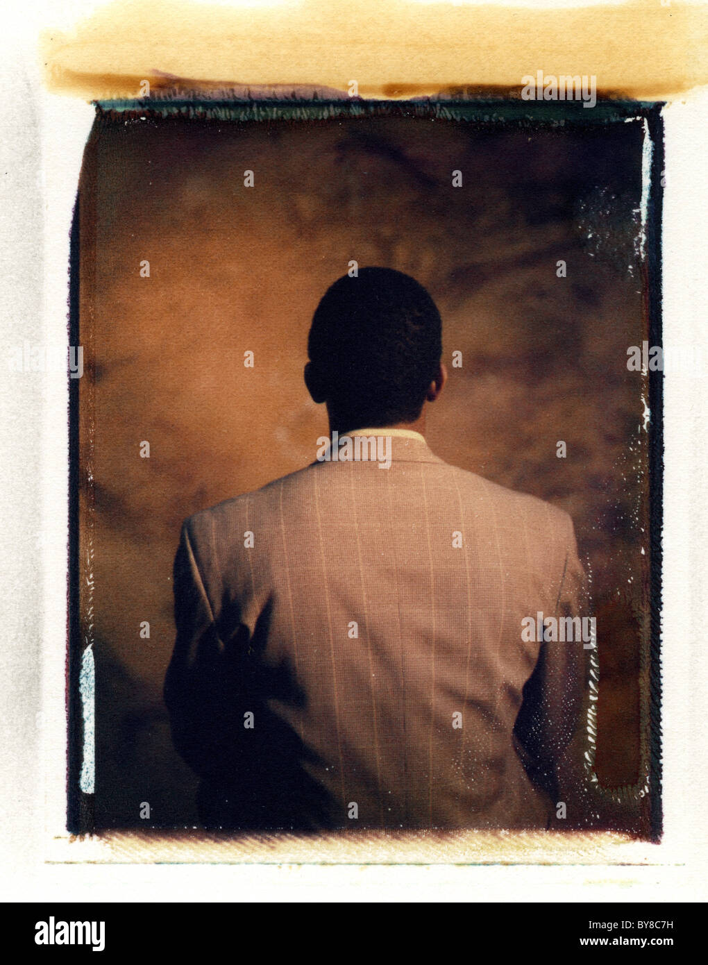 an african american man from behind in a suit Stock Photo