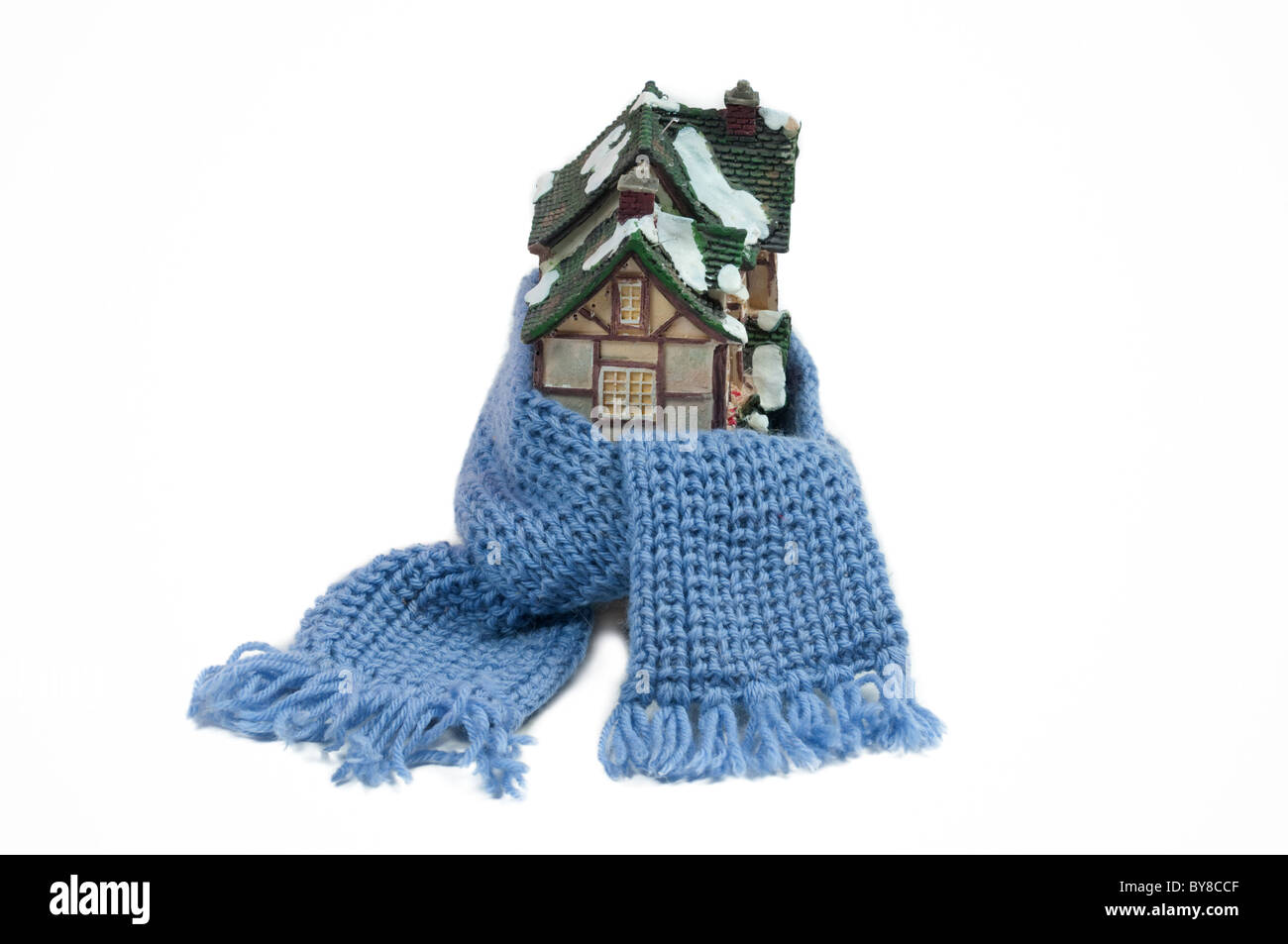 Christmas toy house wrapped in blue hand made shawl - conceptual view of protecting or isolating house Stock Photo