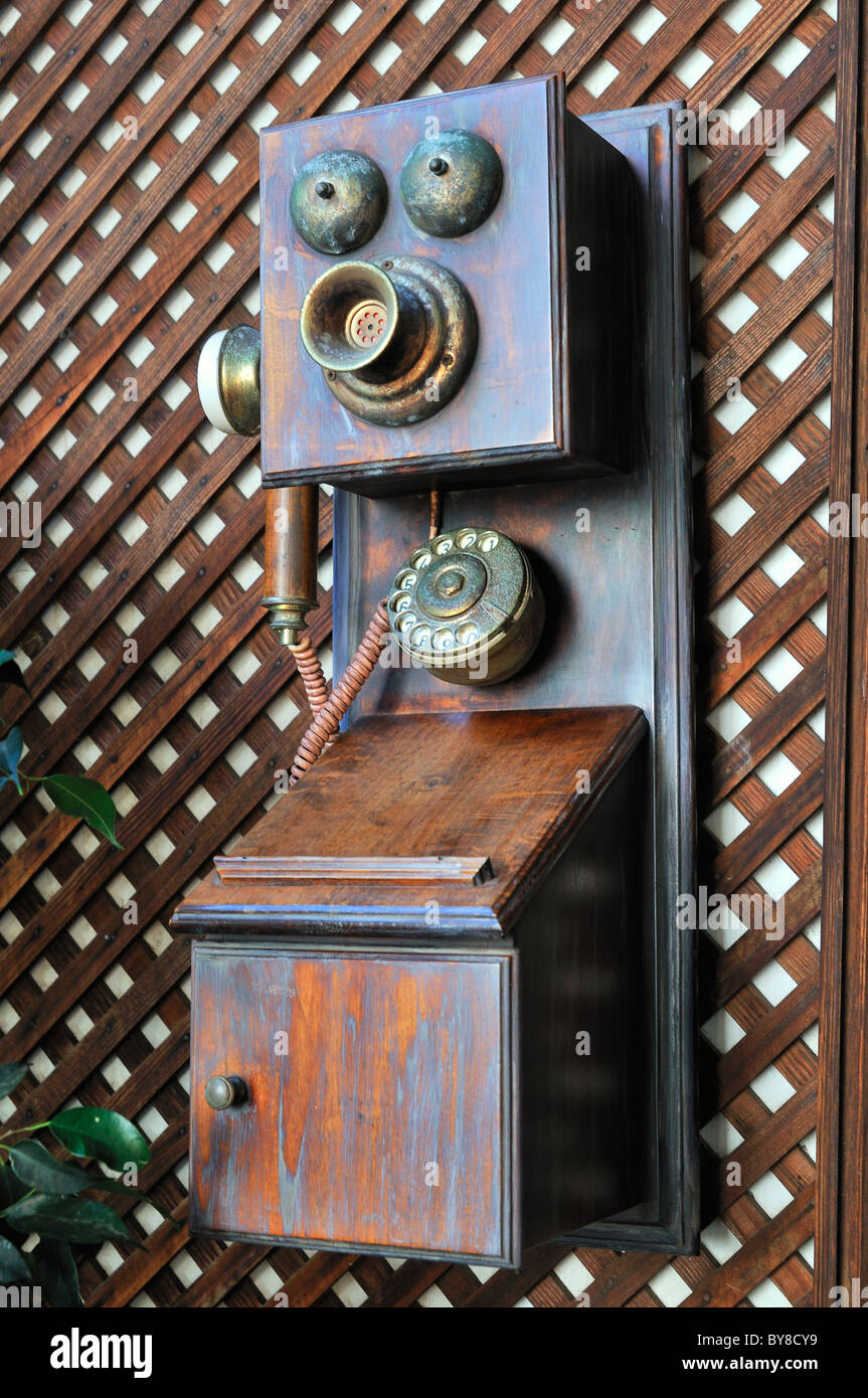 Vintage telephone hanging on the wall hires stock photography and
