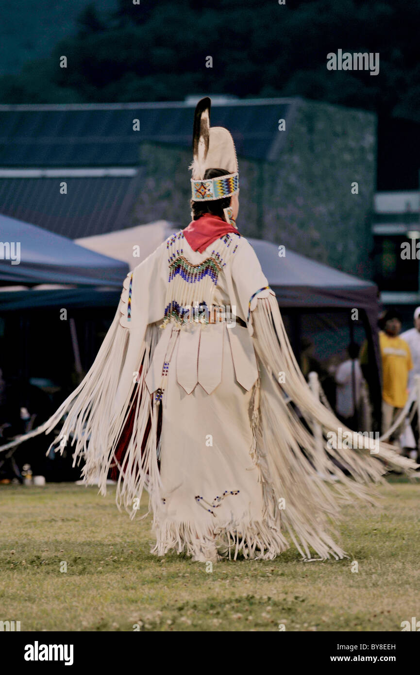 Head Lady dancer in white buckskin makes her grand entrance into the Pow Wow dance ring in Cherokee, North Carolina Stock Photo