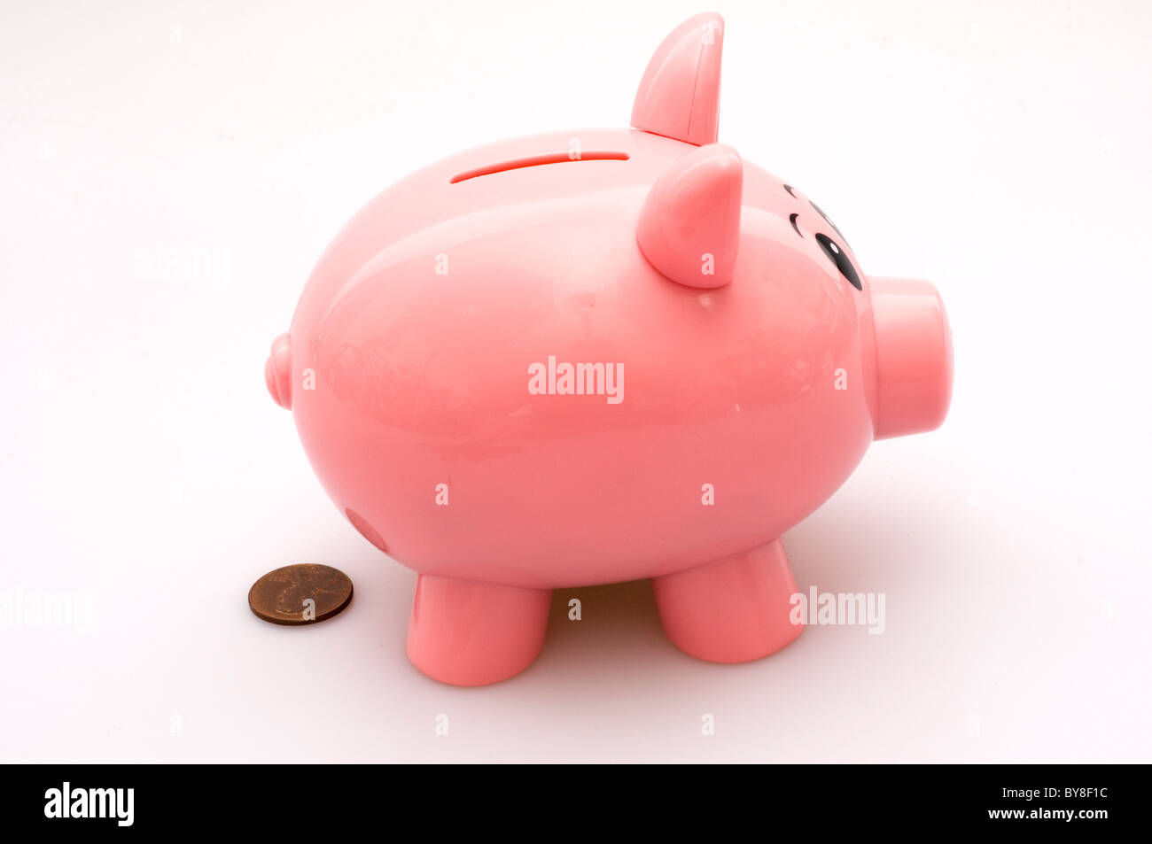 Piggy Bank Pooping a Penny. Stock Photo