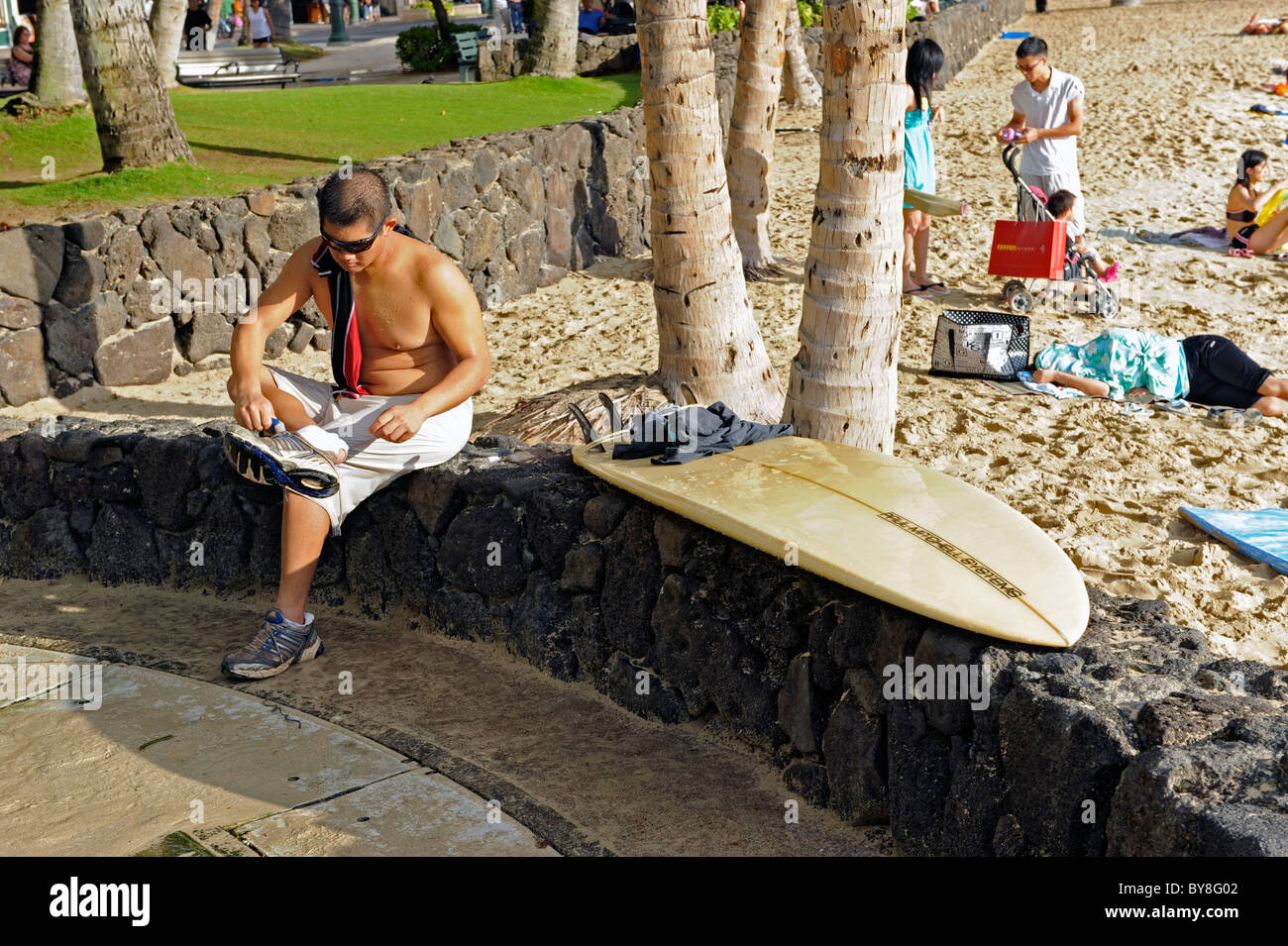 Young Male Polynesian Surfer on Waikiki Beach Hawaii Honolulu Oahu Pacific Ocean  Stock Photo