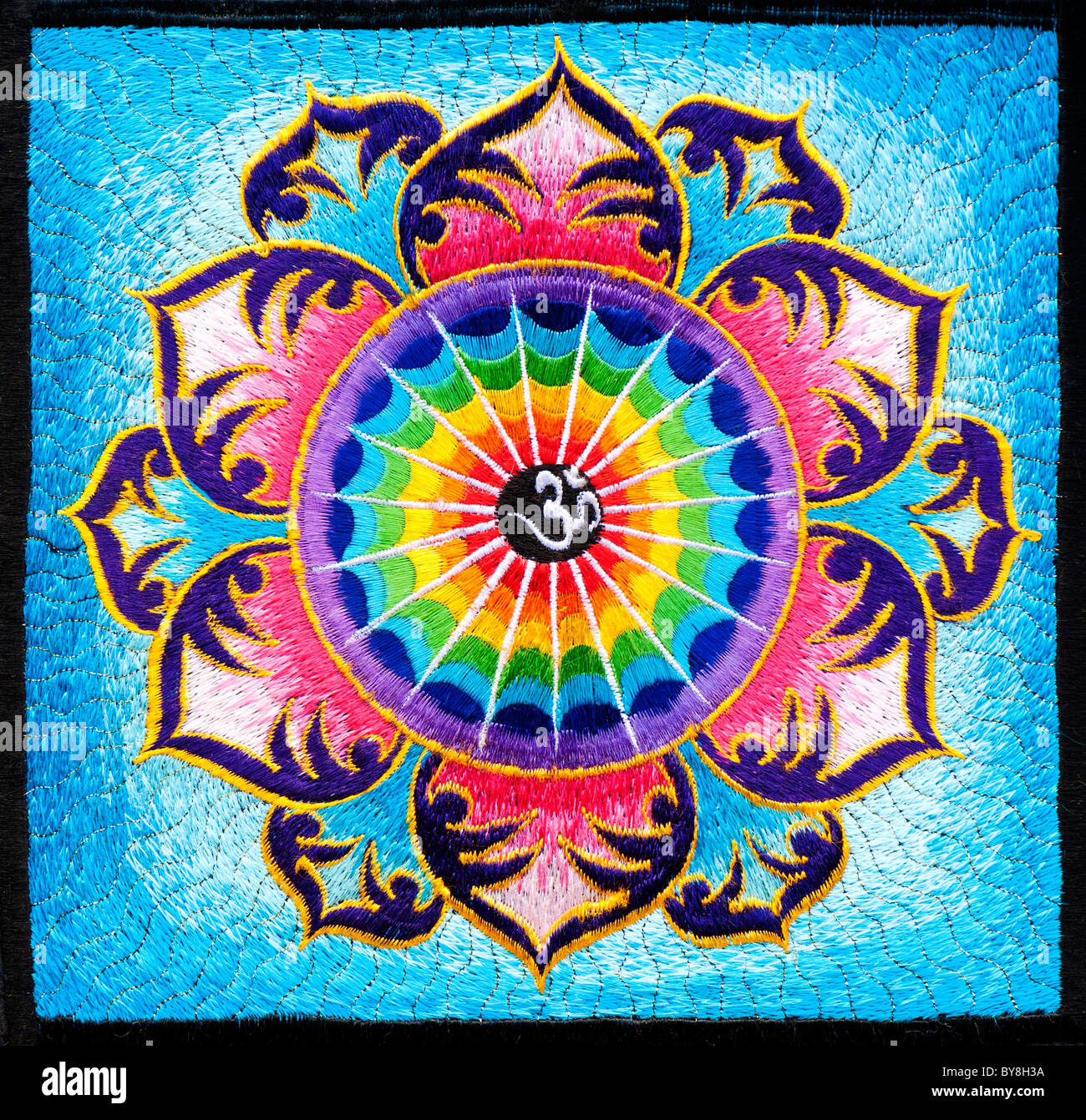 Multicoloured Hindu OM / AUM and lotus flower embroidery pattern. Indian  handicraft. India Stock Photo - Alamy
