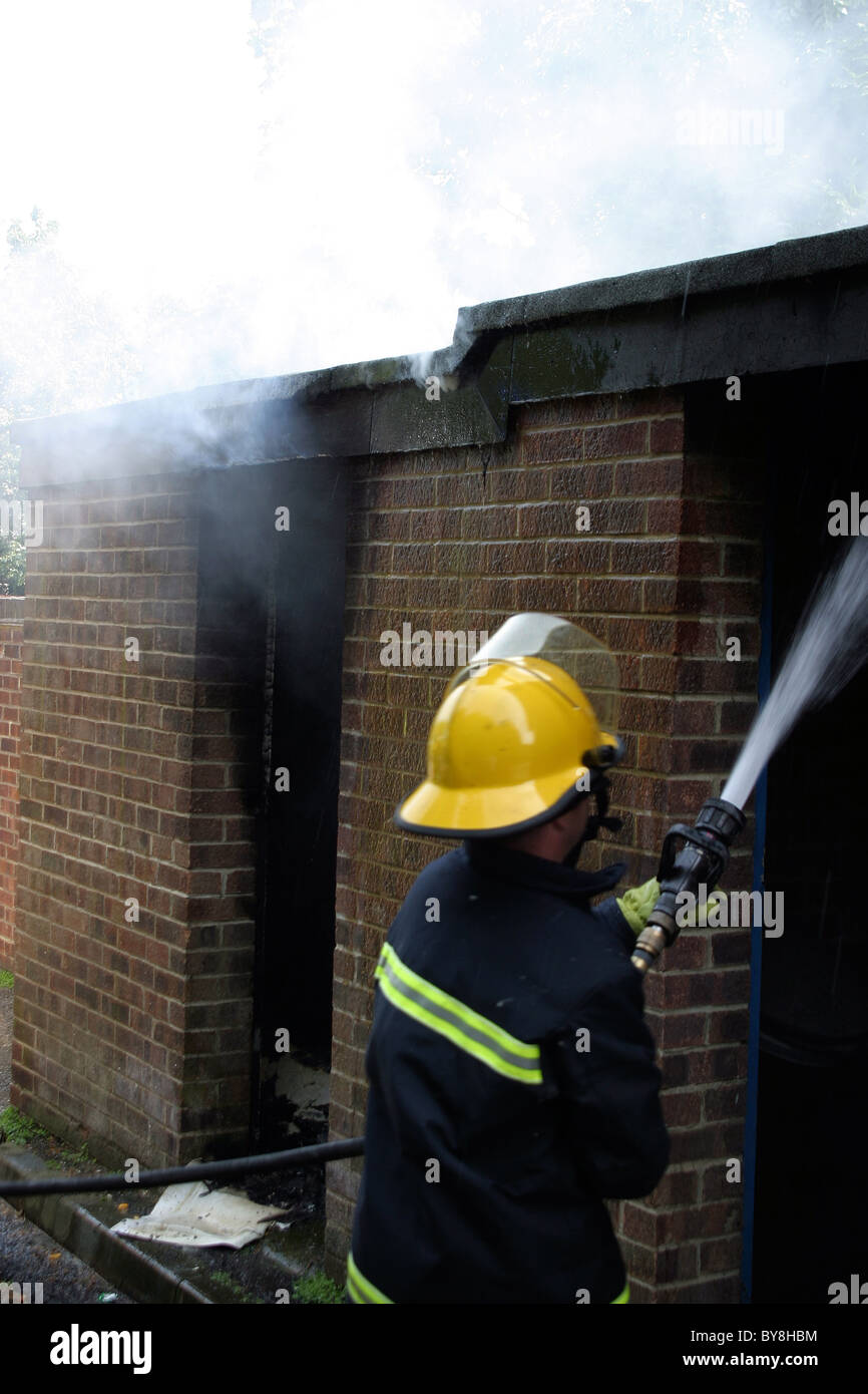fireman using a hose Stock Photo - Alamy