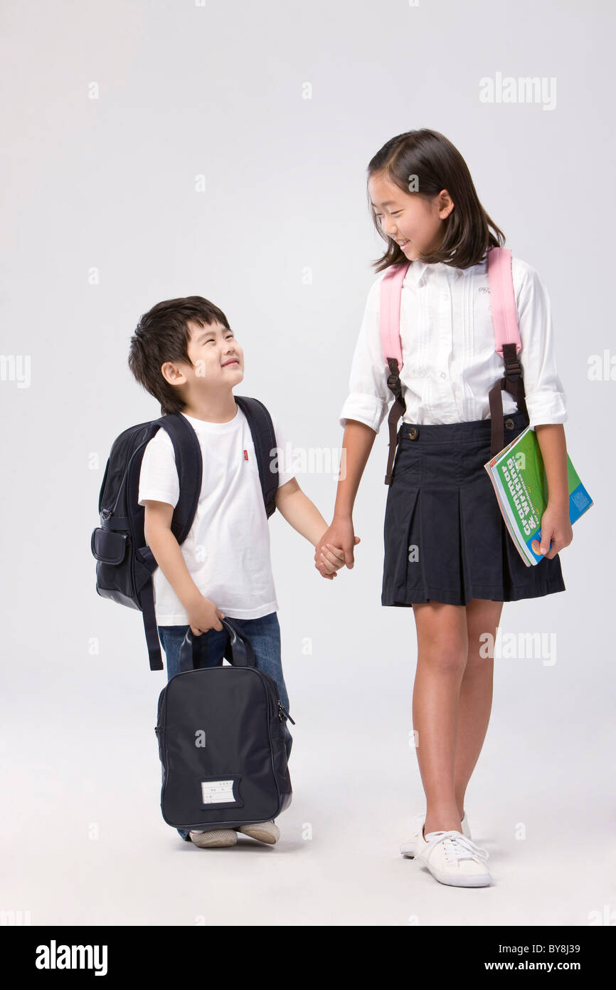 Boy and girl students with school bags Stock Photo Alamy