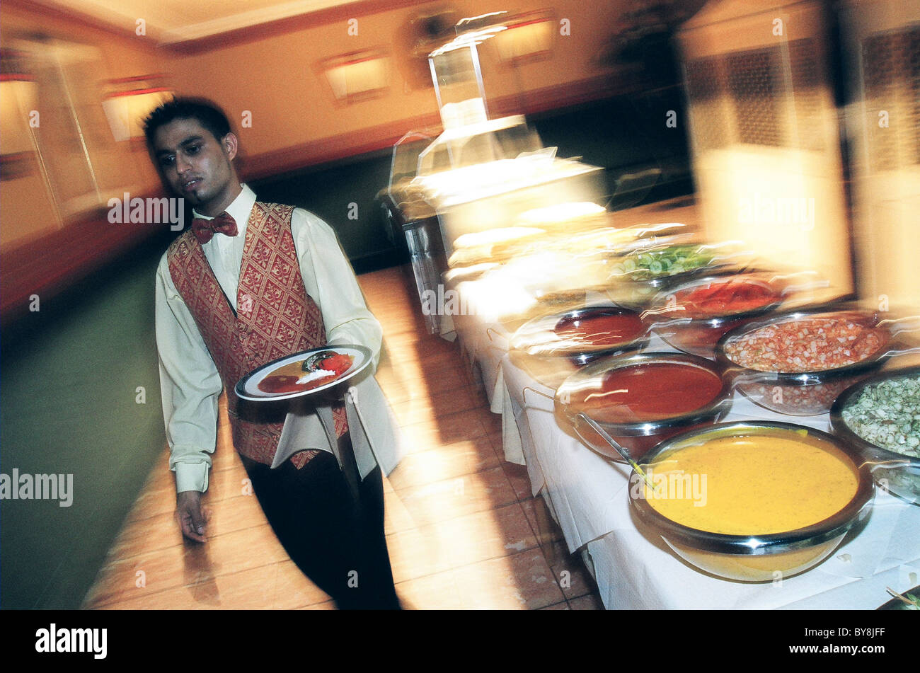 Waiter serving food Stock Photo Alamy