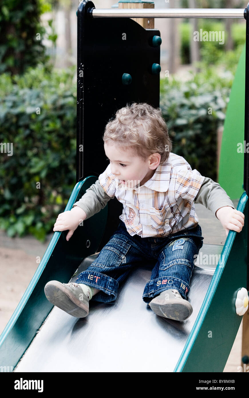 Child playing on a slide Stock Photo