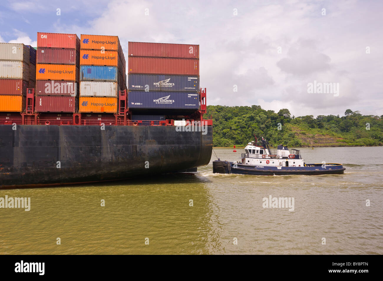 PANAMA - Hapag-Lloyd container ship and tugboat on Panama Canal. Stock Photo