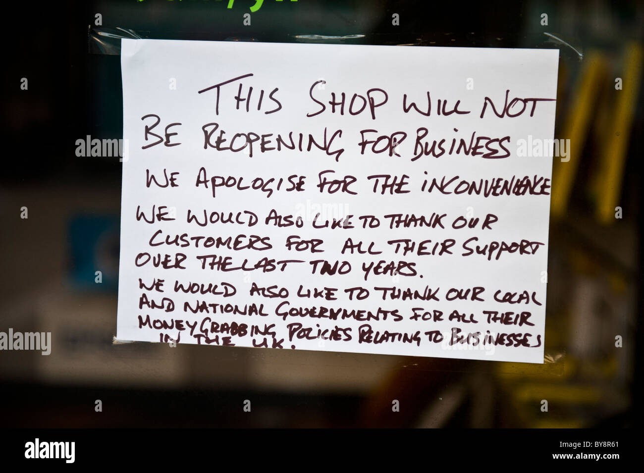 A handwritten protest notice sign in the window of a closed down shop, UK Stock Photo