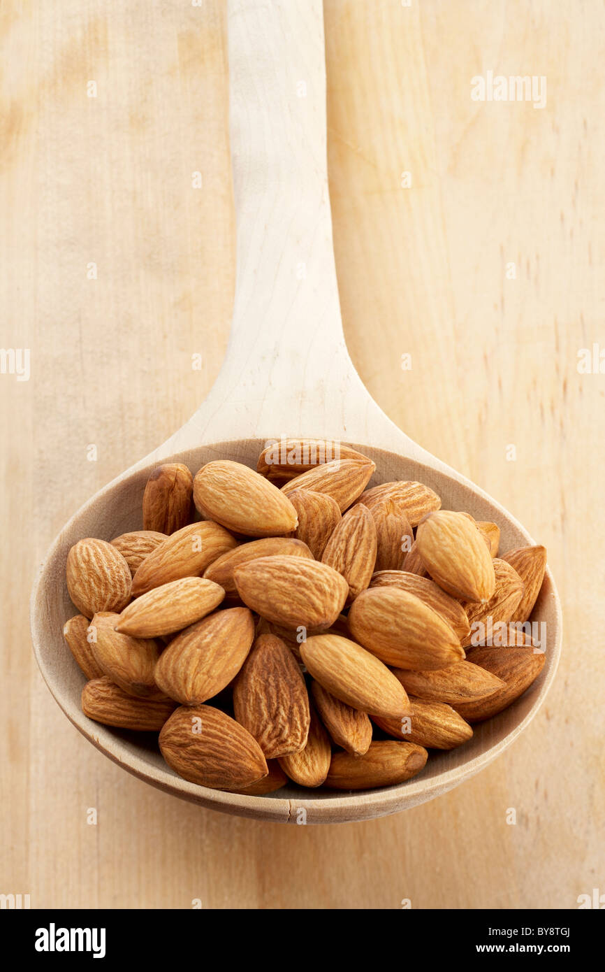 Almonds on a wooden spoon Stock Photo