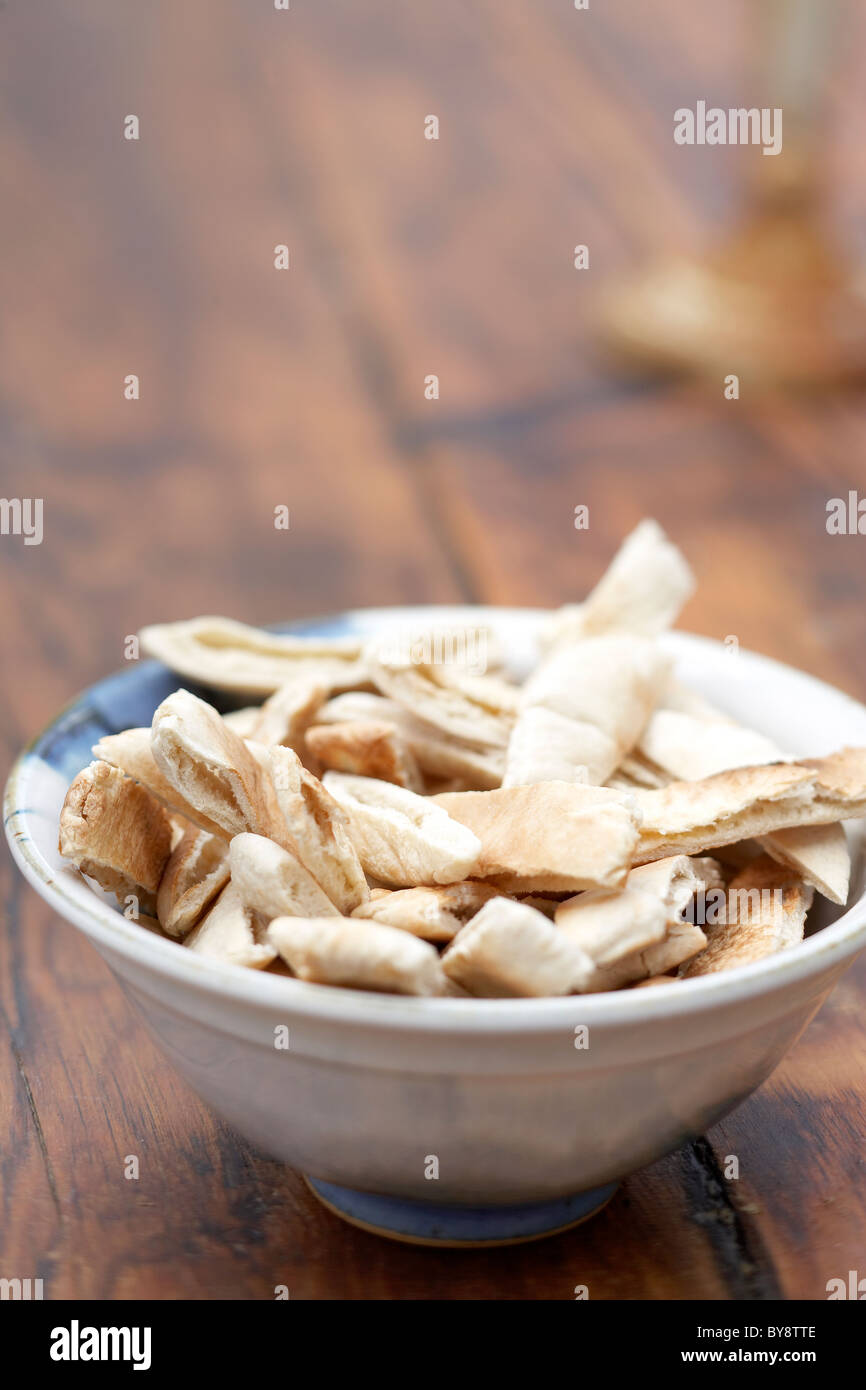 Toasted pitta bread in bowl on wooden table Stock Photo