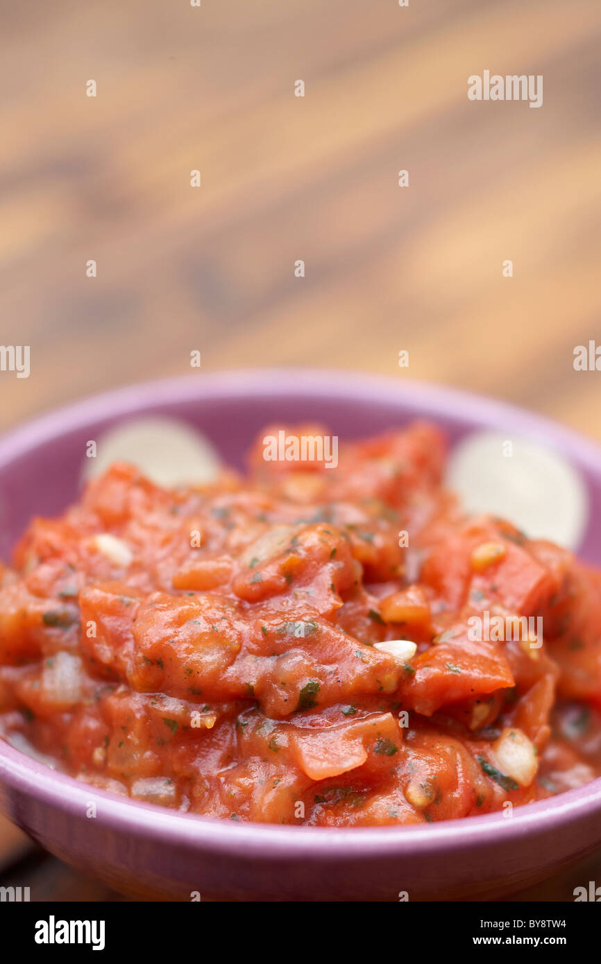 Salsa in bowl on wooden background Stock Photo