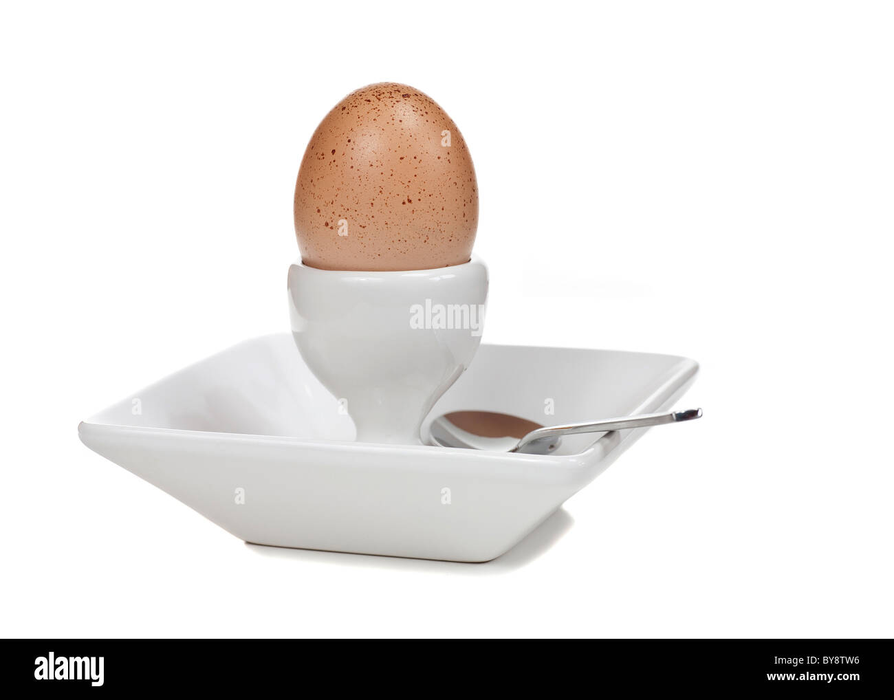 A free-range boiled egg with spoon. White background. Stock Photo