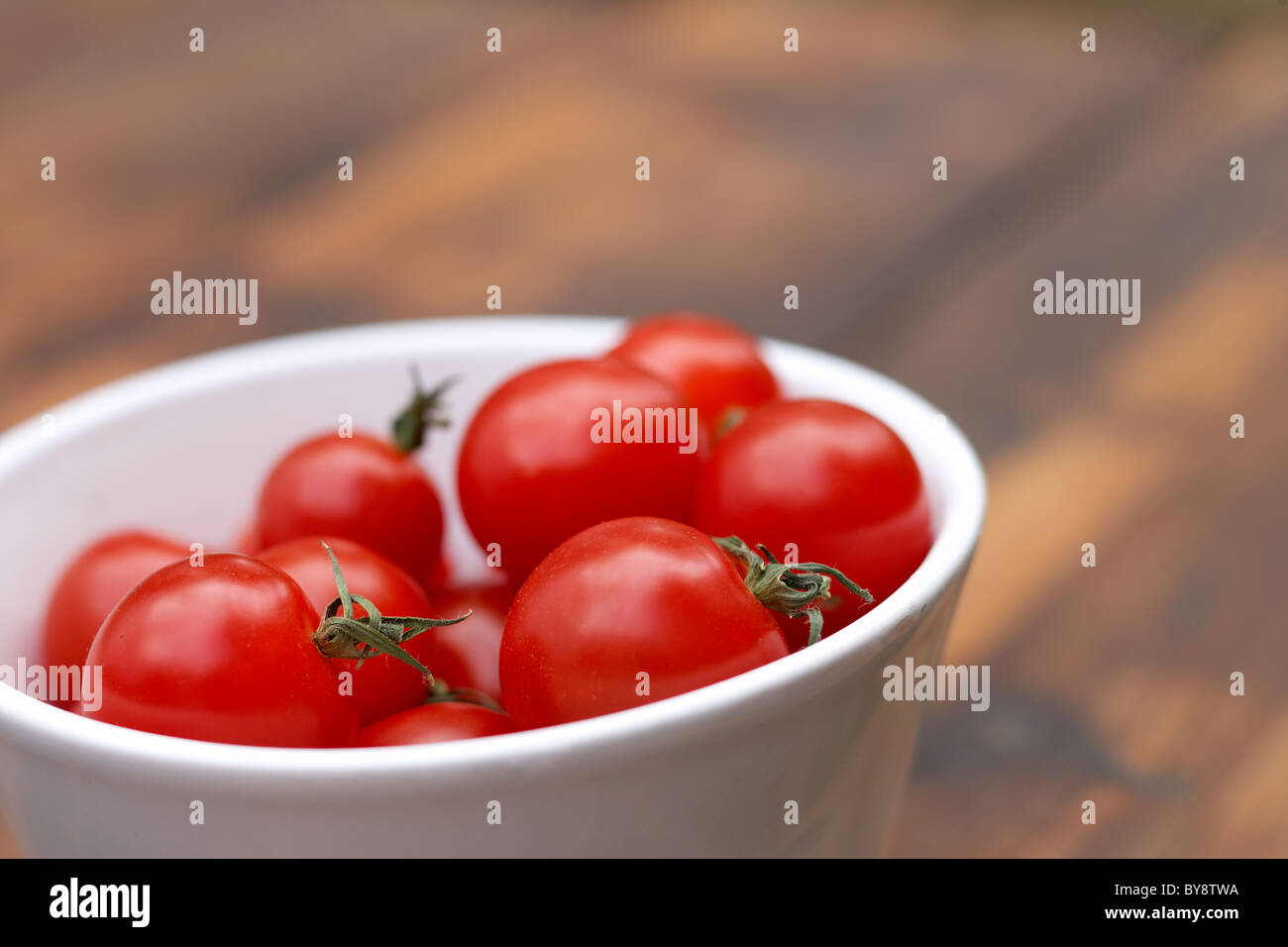 Cherry tomatoes in small white bowl Stock Photo