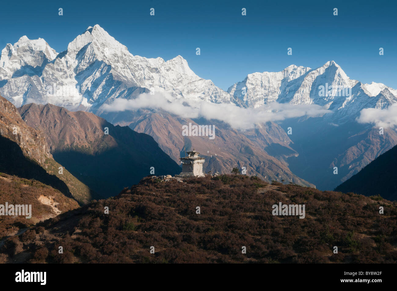 Thamserku and Kusum Kangeru peaks rise above the Thame Valley in the Everest Region of Nepal Stock Photo