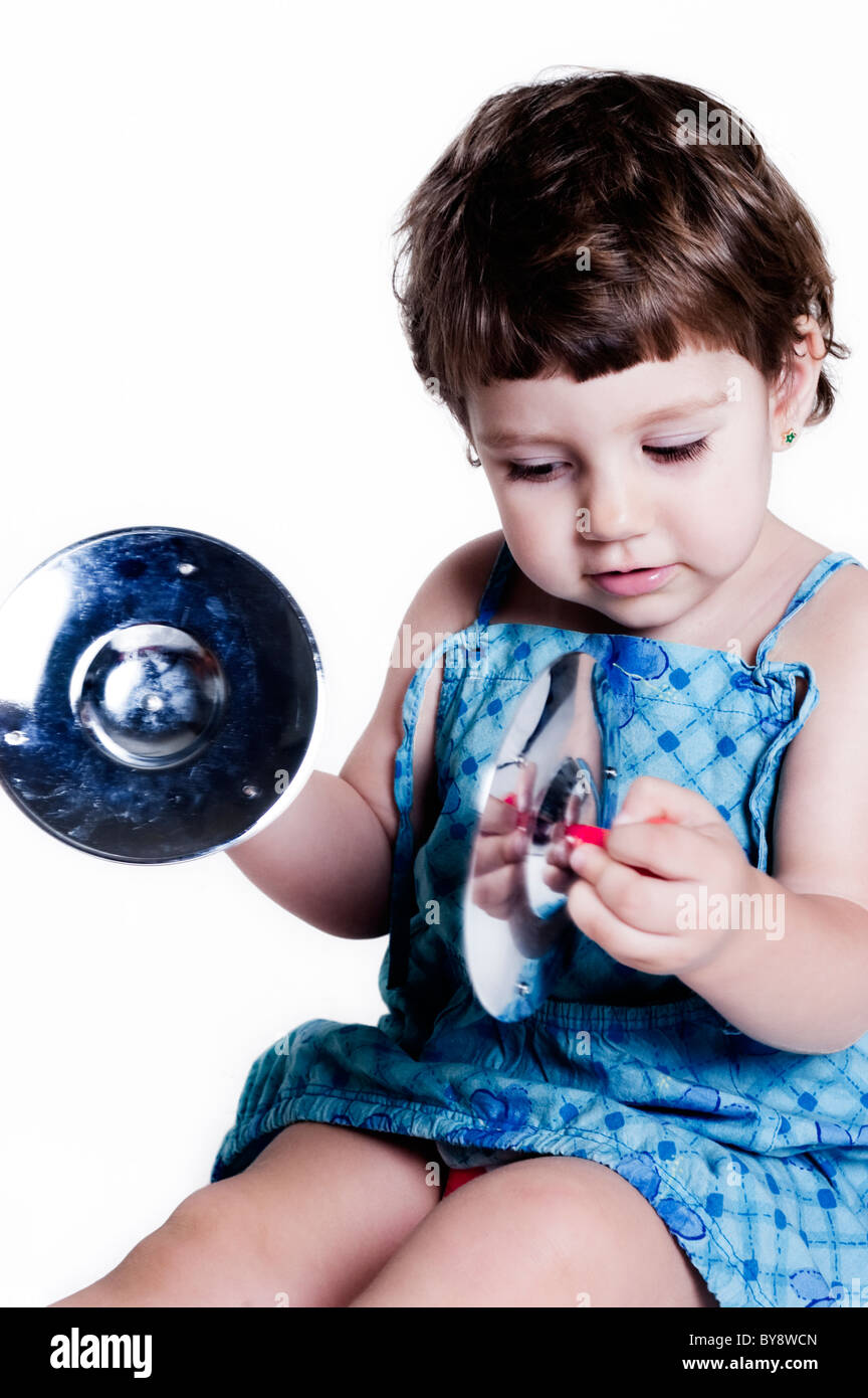 girl playing with a musical instrument. Tambourine Stock Photo Alamy
