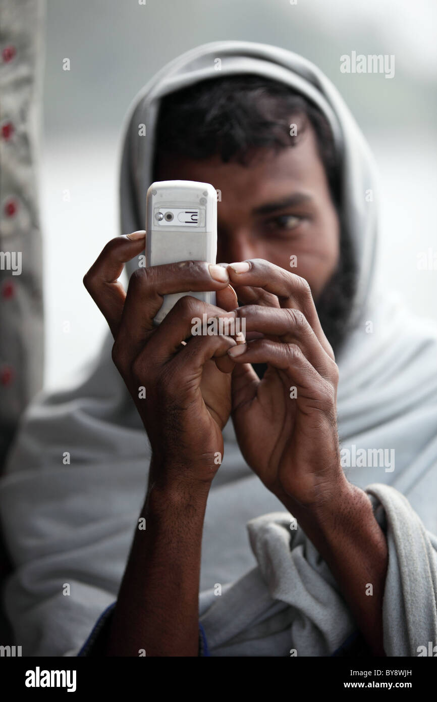 Muslim man with mobile phone in Bangladesh Asia Stock Photo