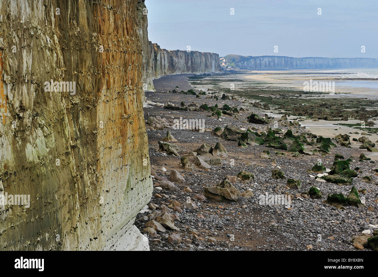 Eroded chalk cliffs rising up from pebble beach at Sotteville-sur-Mer, Normandy, France Stock Photo