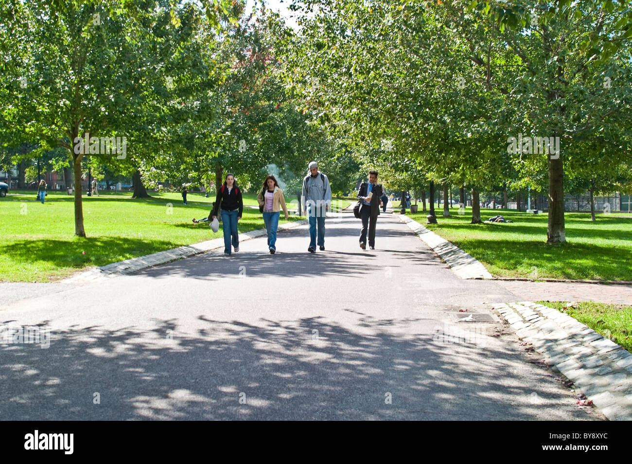 Four people walking through the park in Boston. Stock Photo