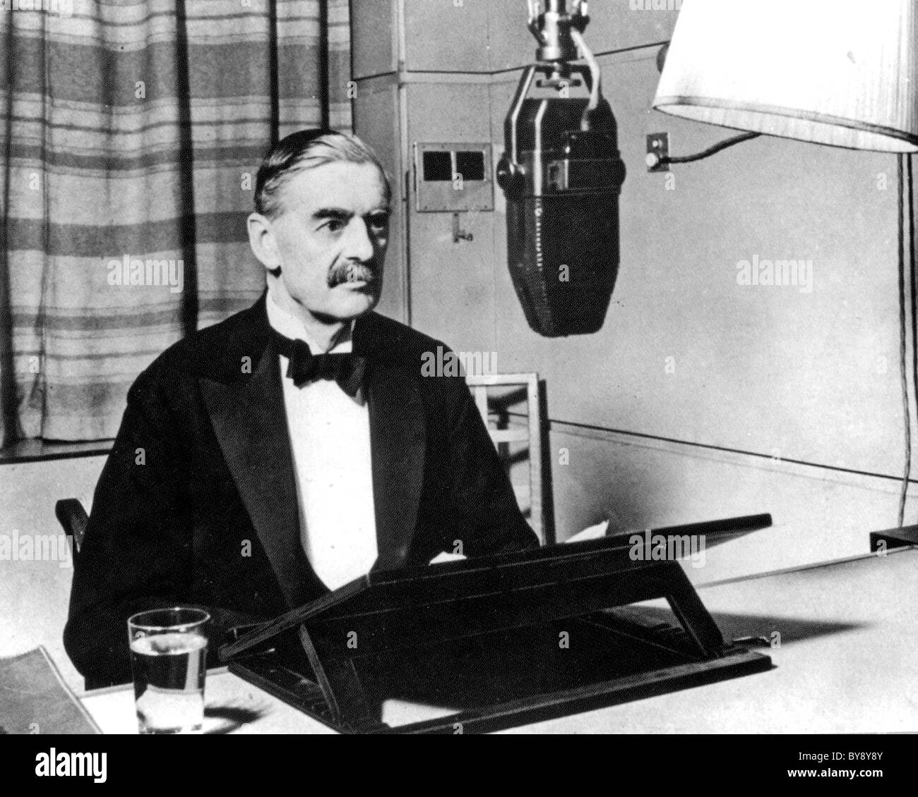 NEVILLE CHAMBERLAIN (1869-1940) as British Prime Minister broadcasting the declaration of war on Germany 3 September 1939 Stock Photo