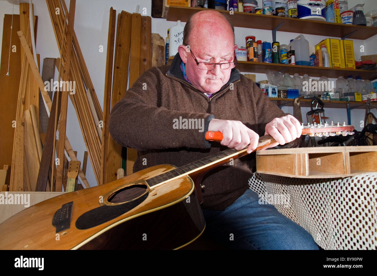 Wooden stringed instrument maker David Graham works on a guitar Stock Photo