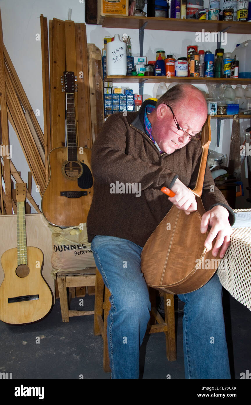 Wooden stringed instrument maker David Graham works on a mandolin Stock Photo