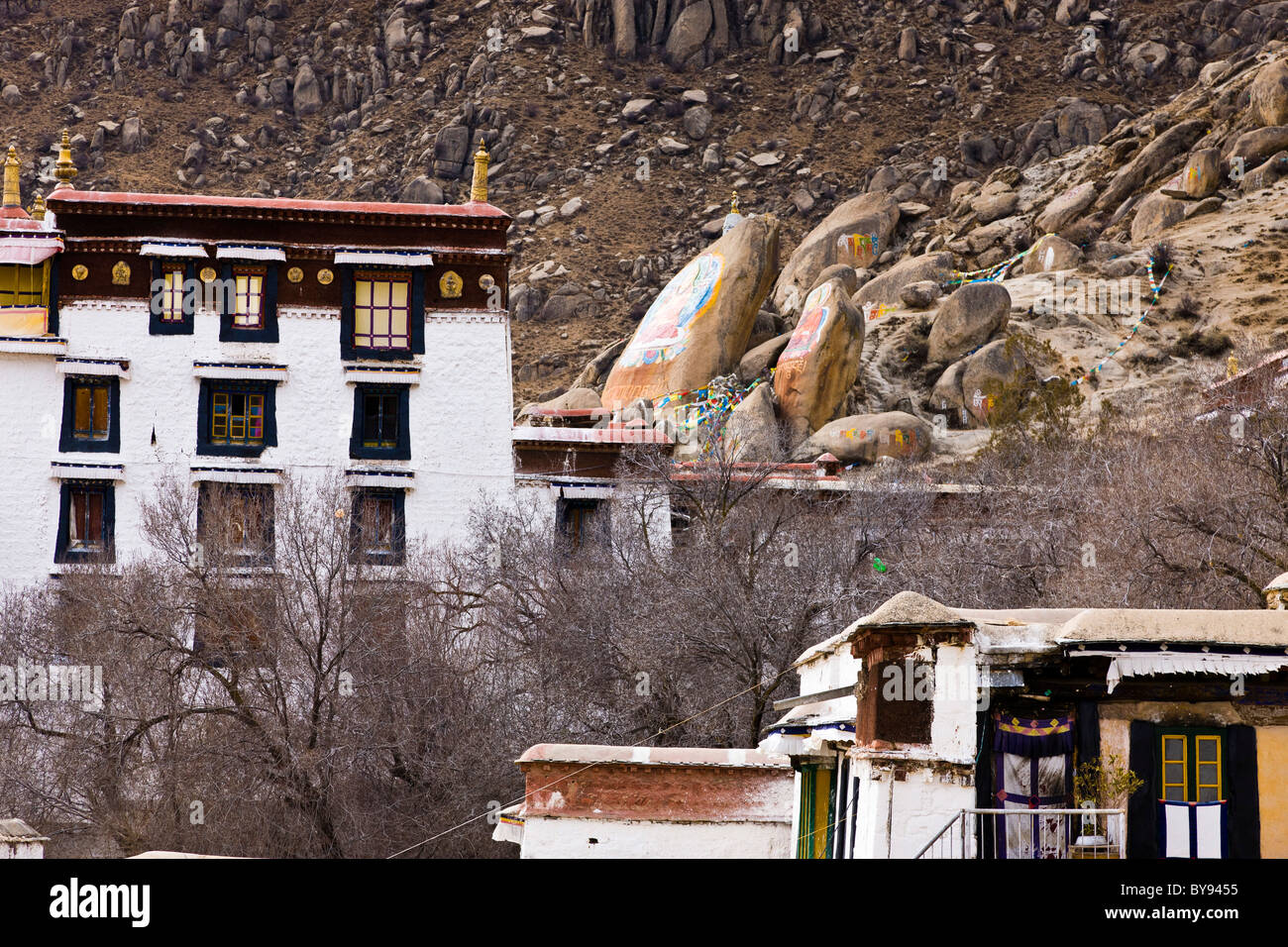 Rock paintings of Buddha above buildings at Drepung Monastery, Lhasa, Tibet. JMH4554 Stock Photo