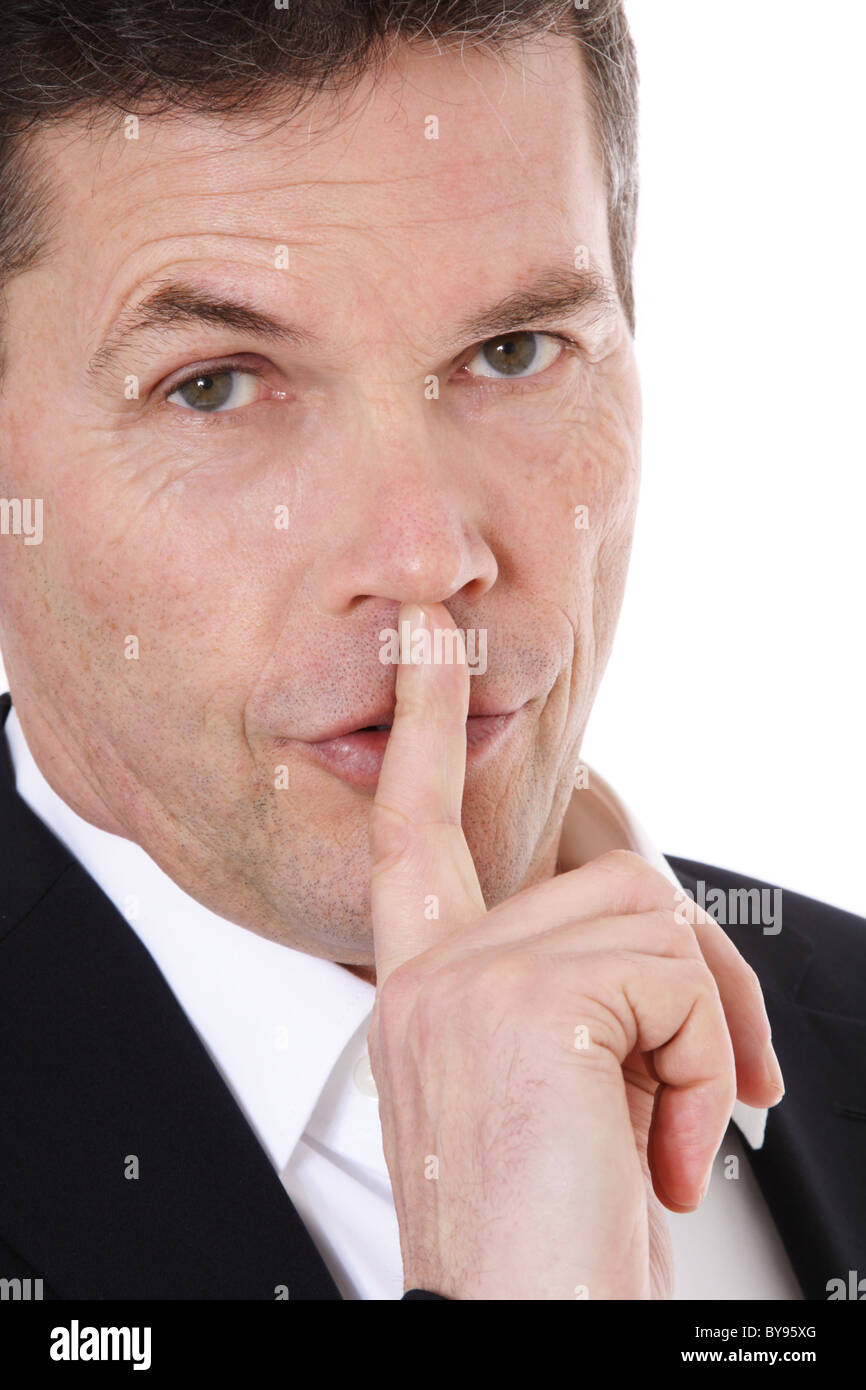 Attractive middle-aged man asks for silence. All on white background. Stock Photo