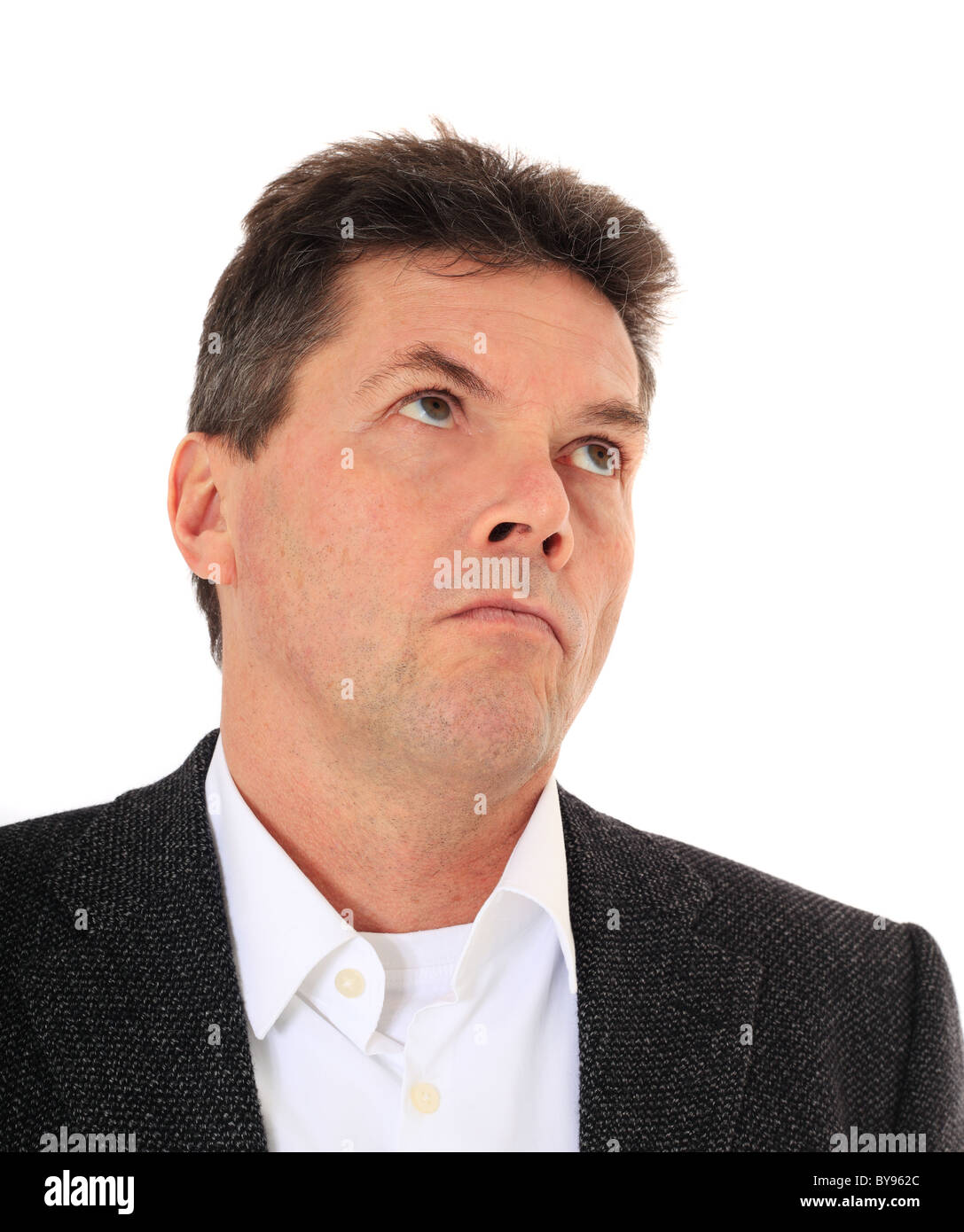 Attractive middle-aged man deliberates a decision. All on white background. Stock Photo