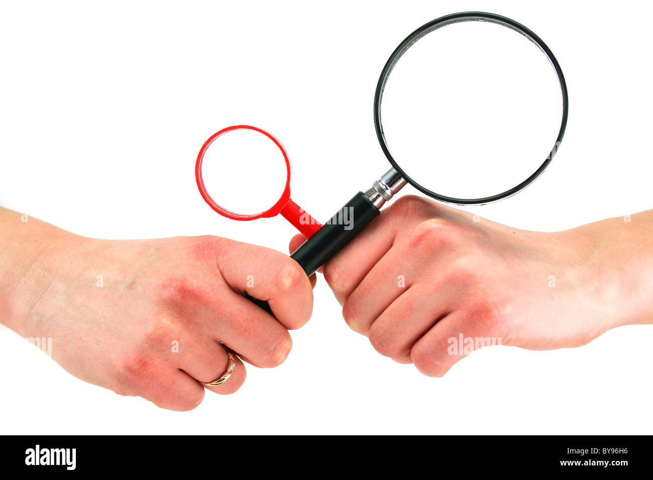 Woman's hands holds two magnifying glasses isolated Stock Photo