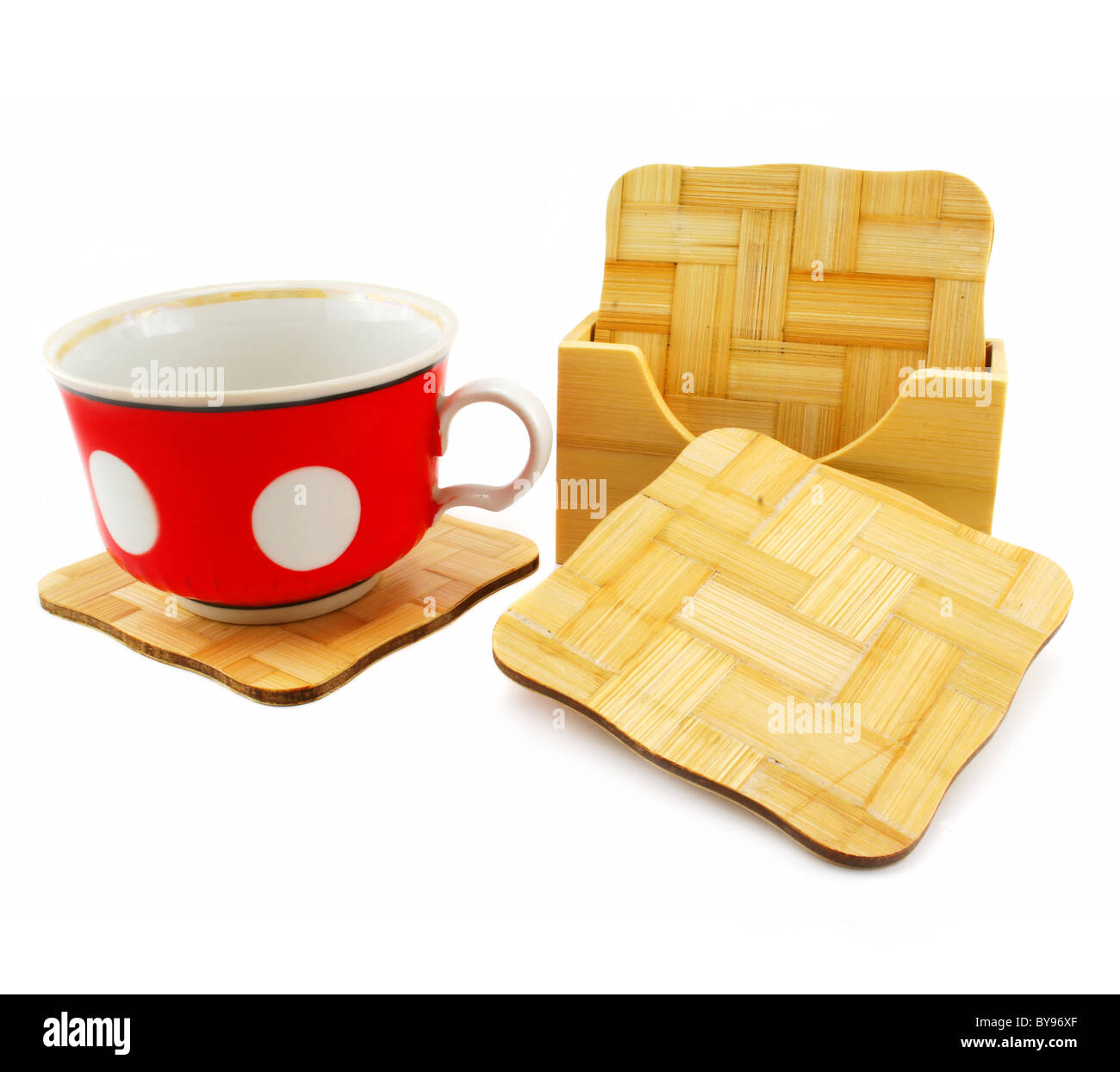Colored cup and set of wooden trivets Stock Photo