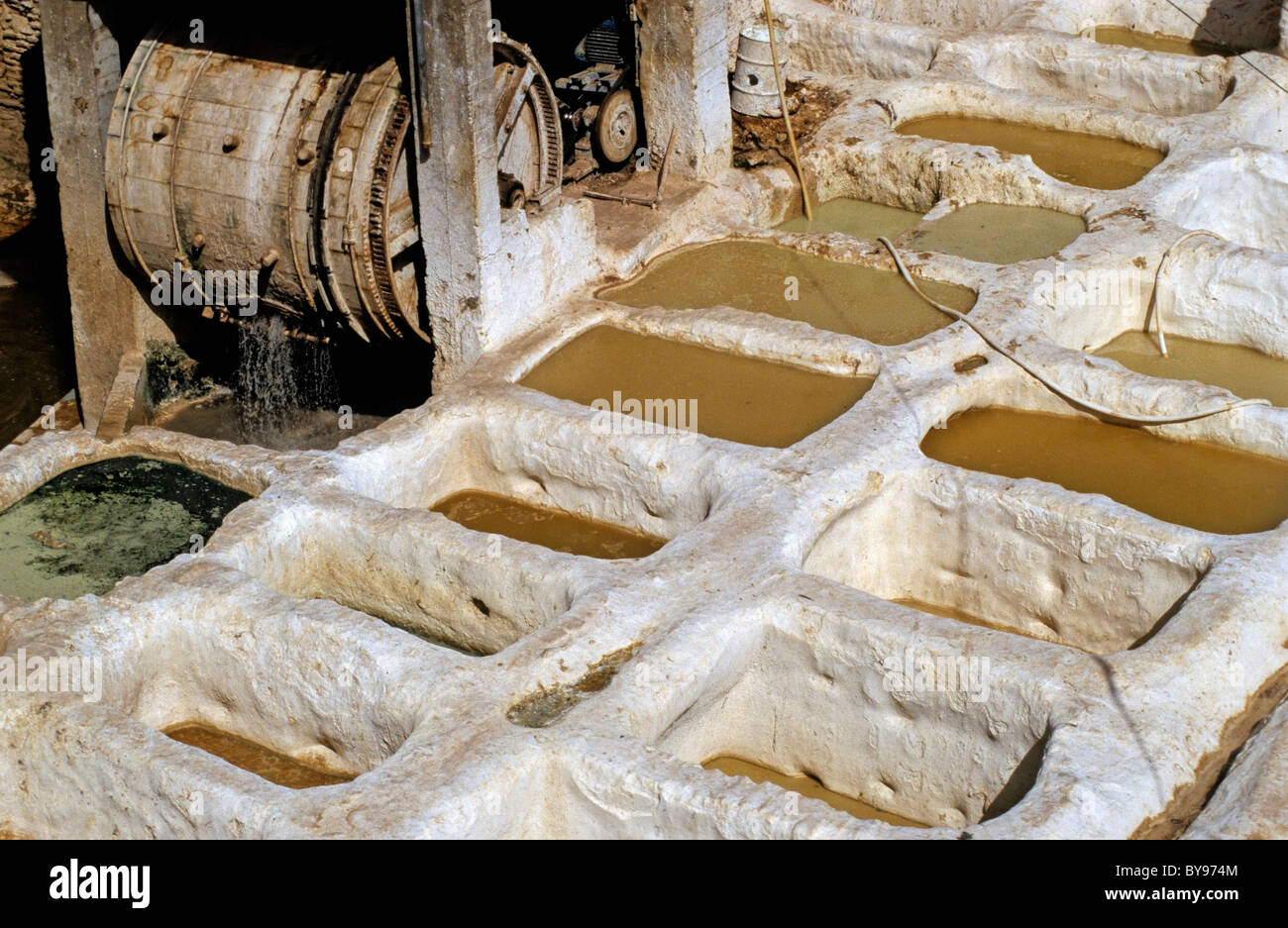 Vats and wooden paddle wheel at a tannery, El Bali, Fez, Morocco. Stock Photo