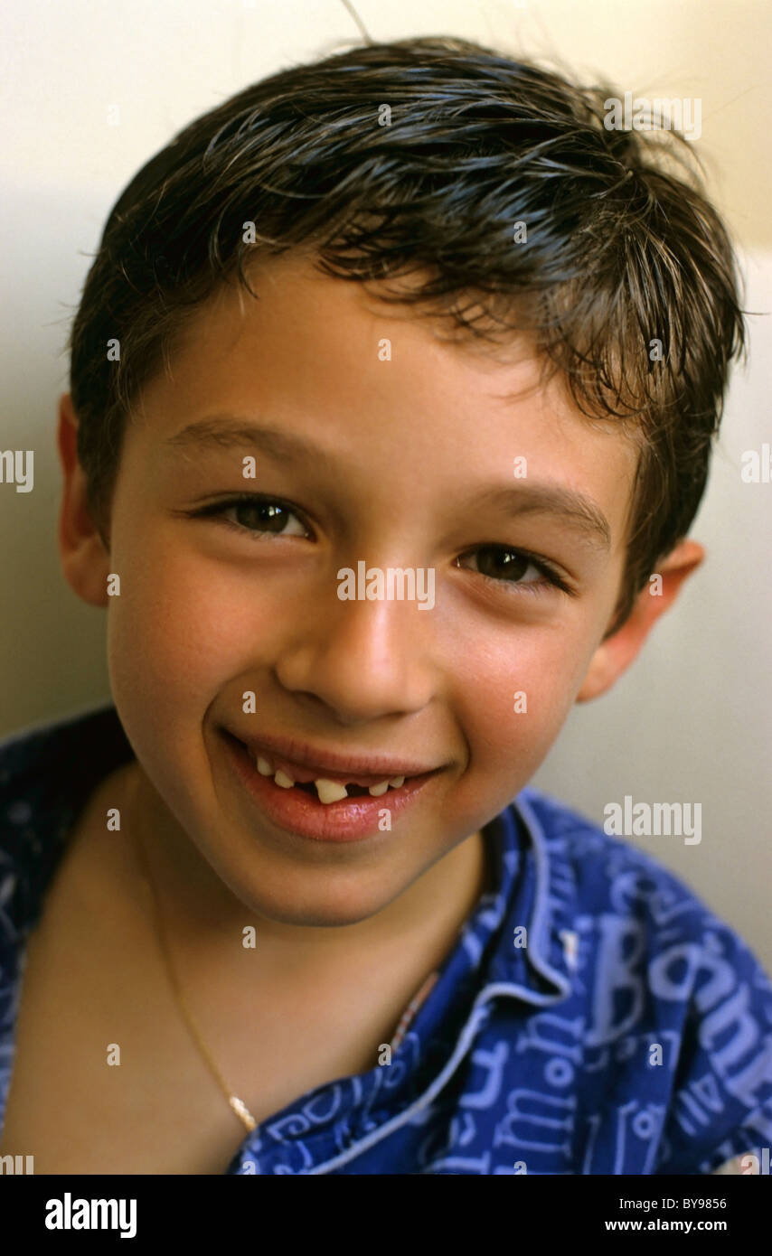 Eight year old boy smiling to reveal missing teeth. Stock Photo
