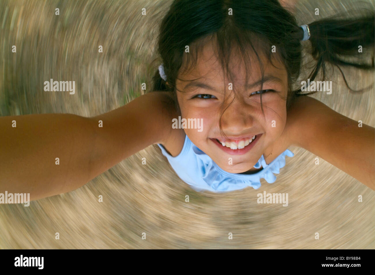 Young girl being spun around, France. Stock Photo