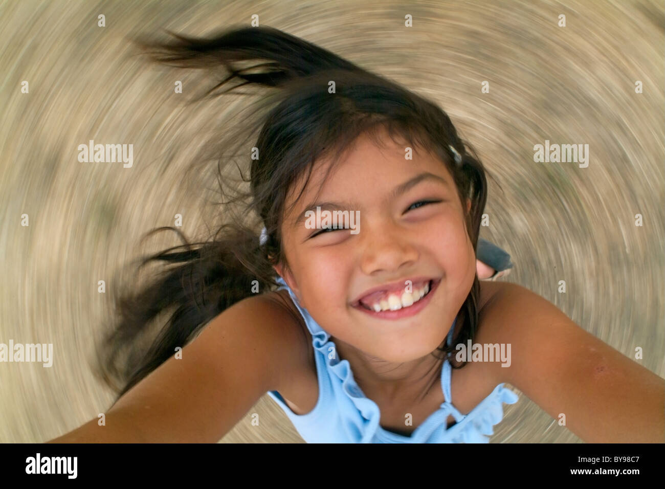 France young girl looking up at camera while spinning Stock Photo - Alamy
