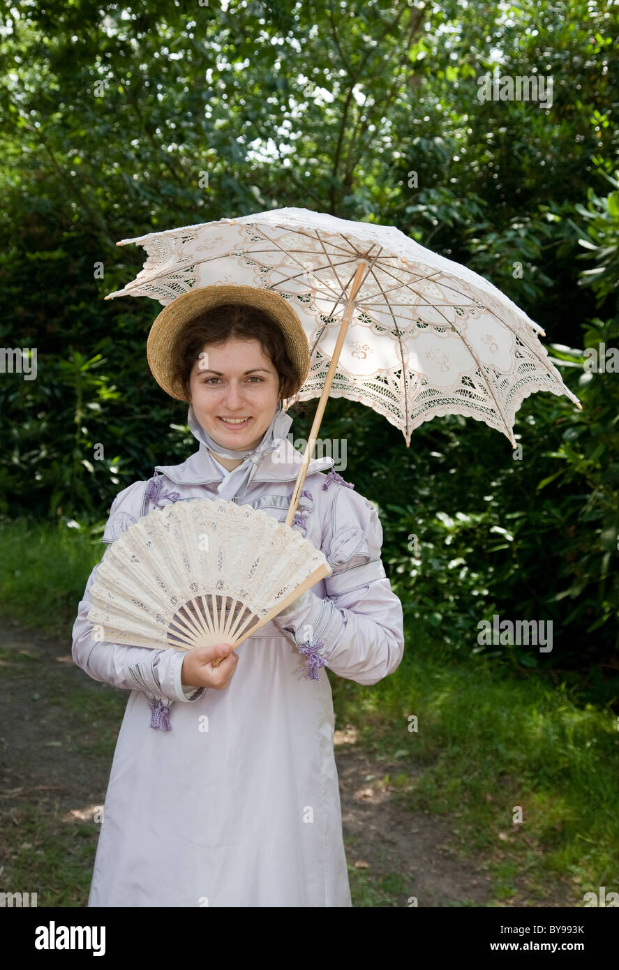 Victorian lady in summer dress with fan and parasol Stock Photo - Alamy