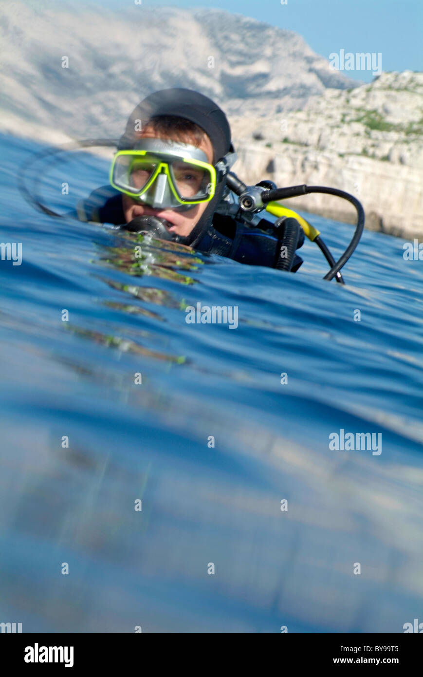 A scuba diver resurfaces in the Mediterranean Sea after diving near Ile de Riou, Marseille, France. Stock Photo