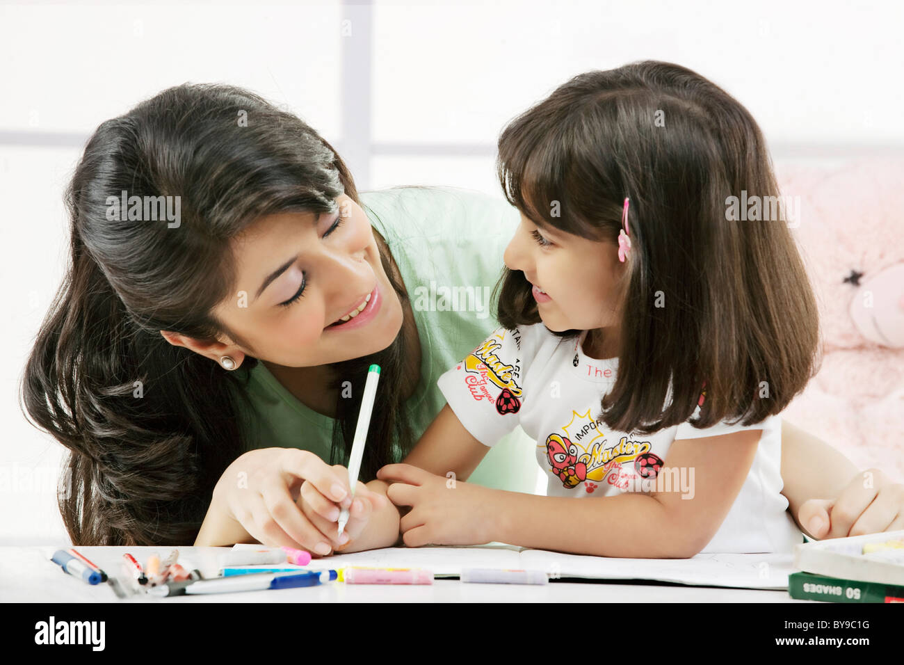 Mother and daughter with a colouring book Stock Photo - Alamy