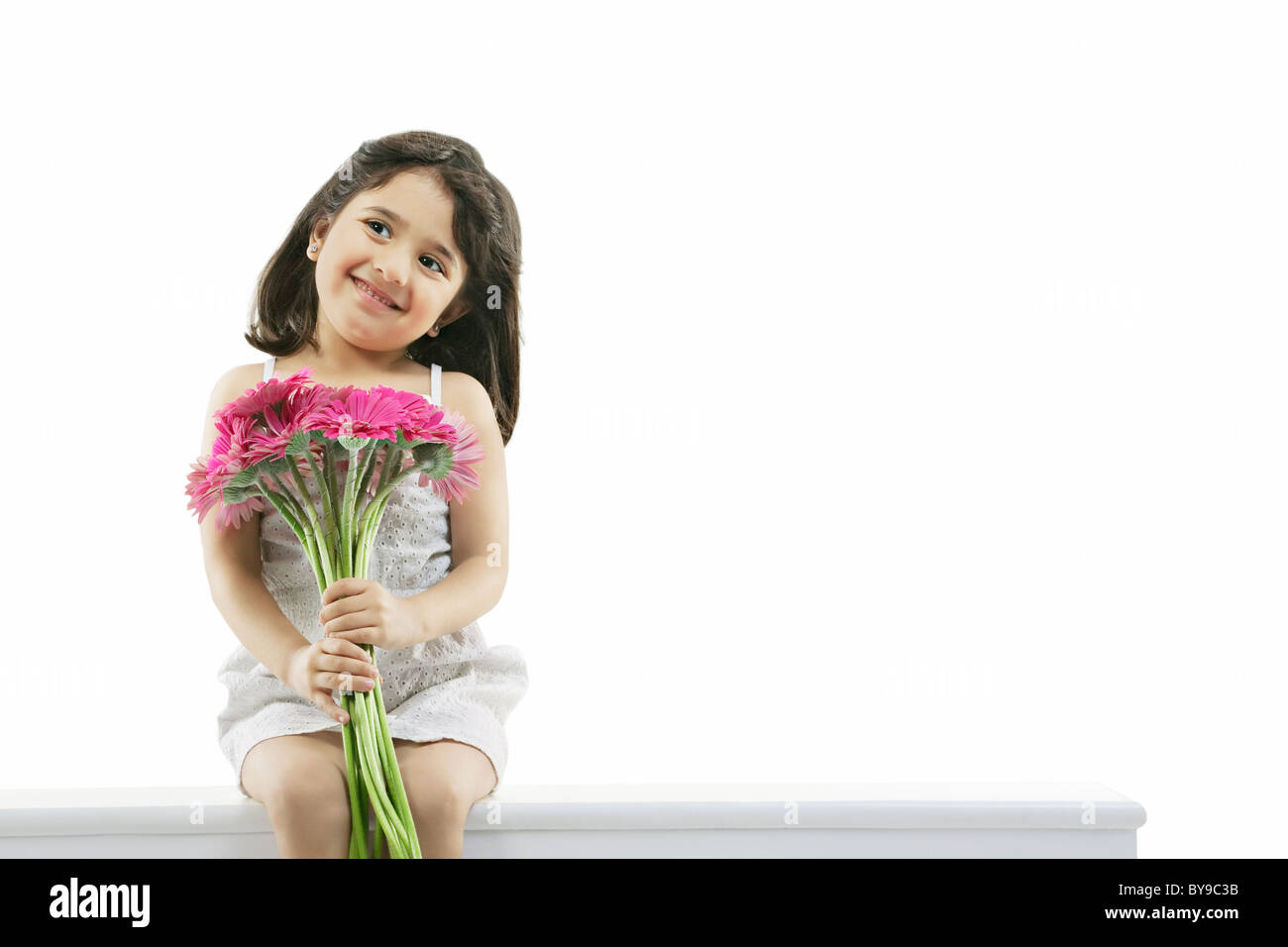 Portrait of a girl holding flowers Stock Photo - Alamy