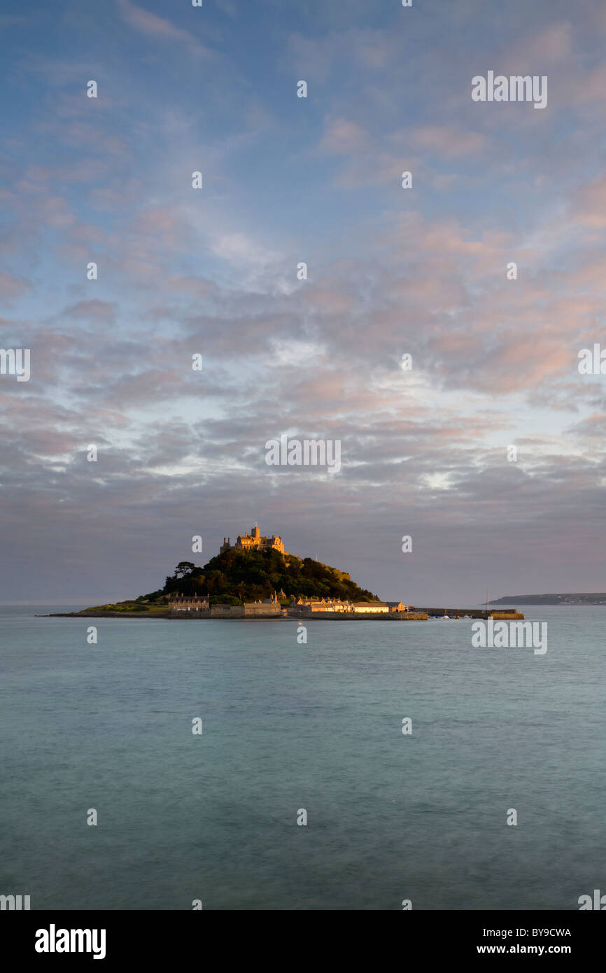 St. Michael's Mount, Cornwall, at sunset The high tide is covering the causeway leading to the island. Stock Photo