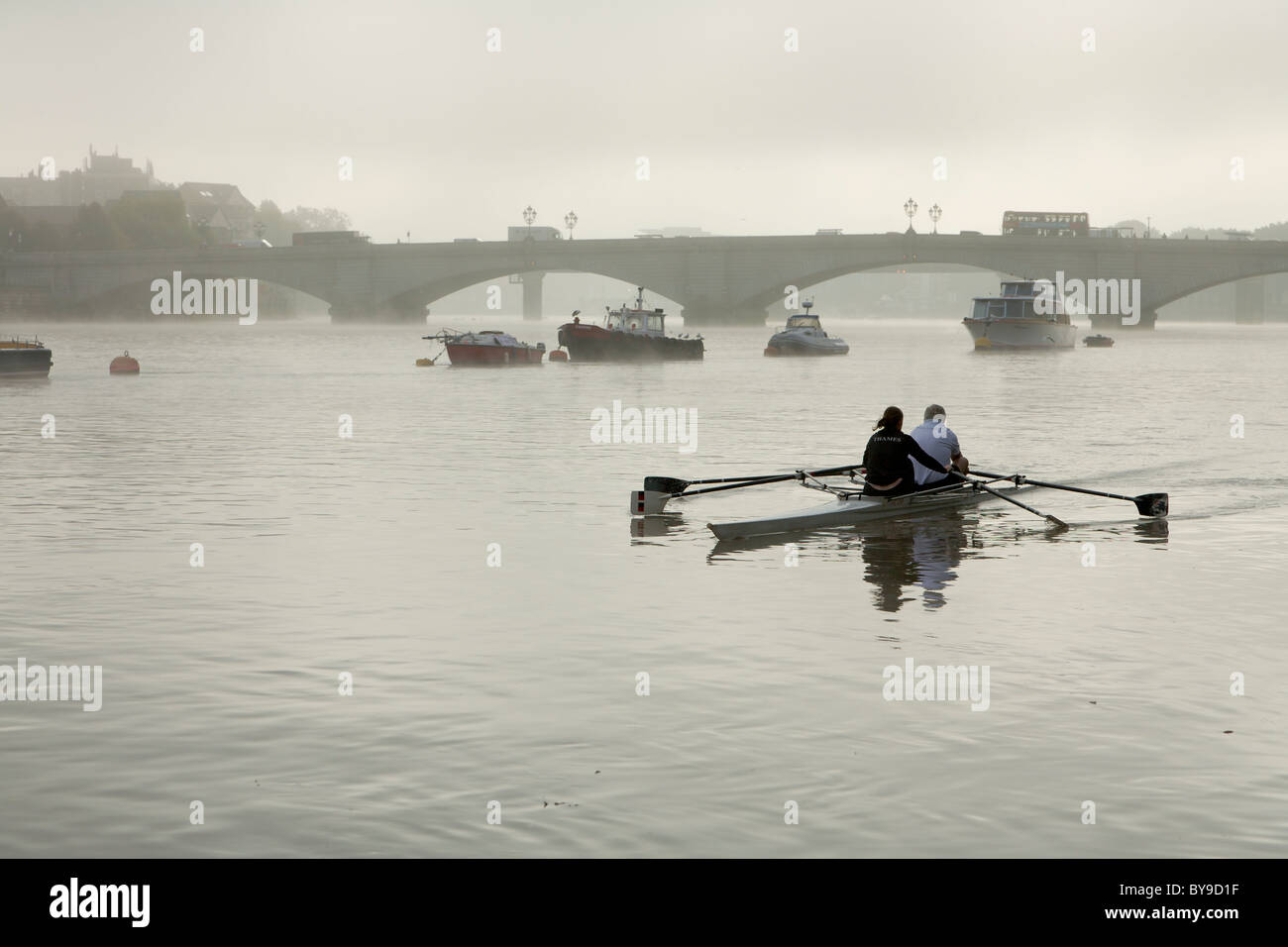 A pair of scullers on the river Thames at Putney, south west London Stock Photo