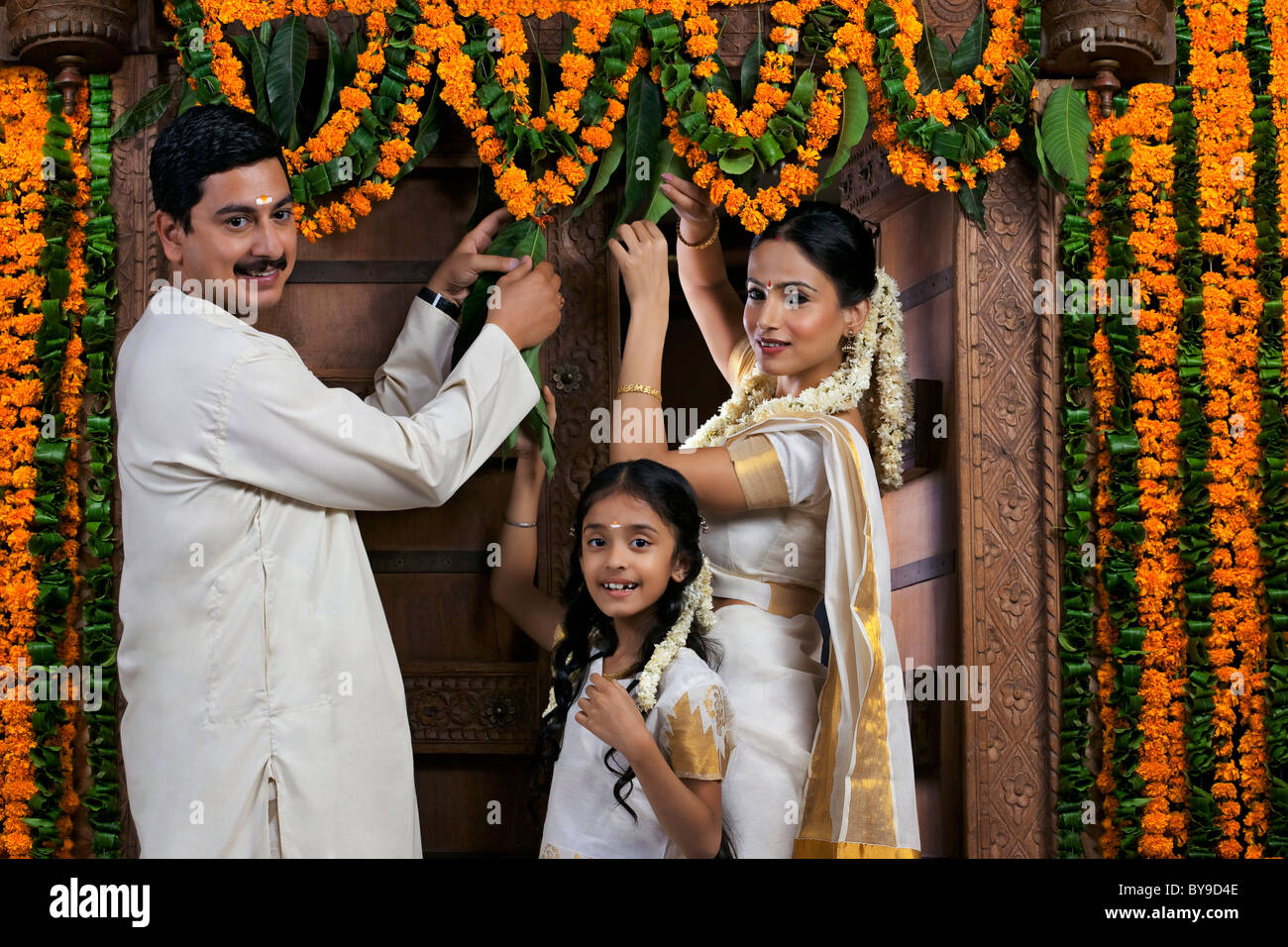 South Indian family decorating during Onam festival Stock Photo