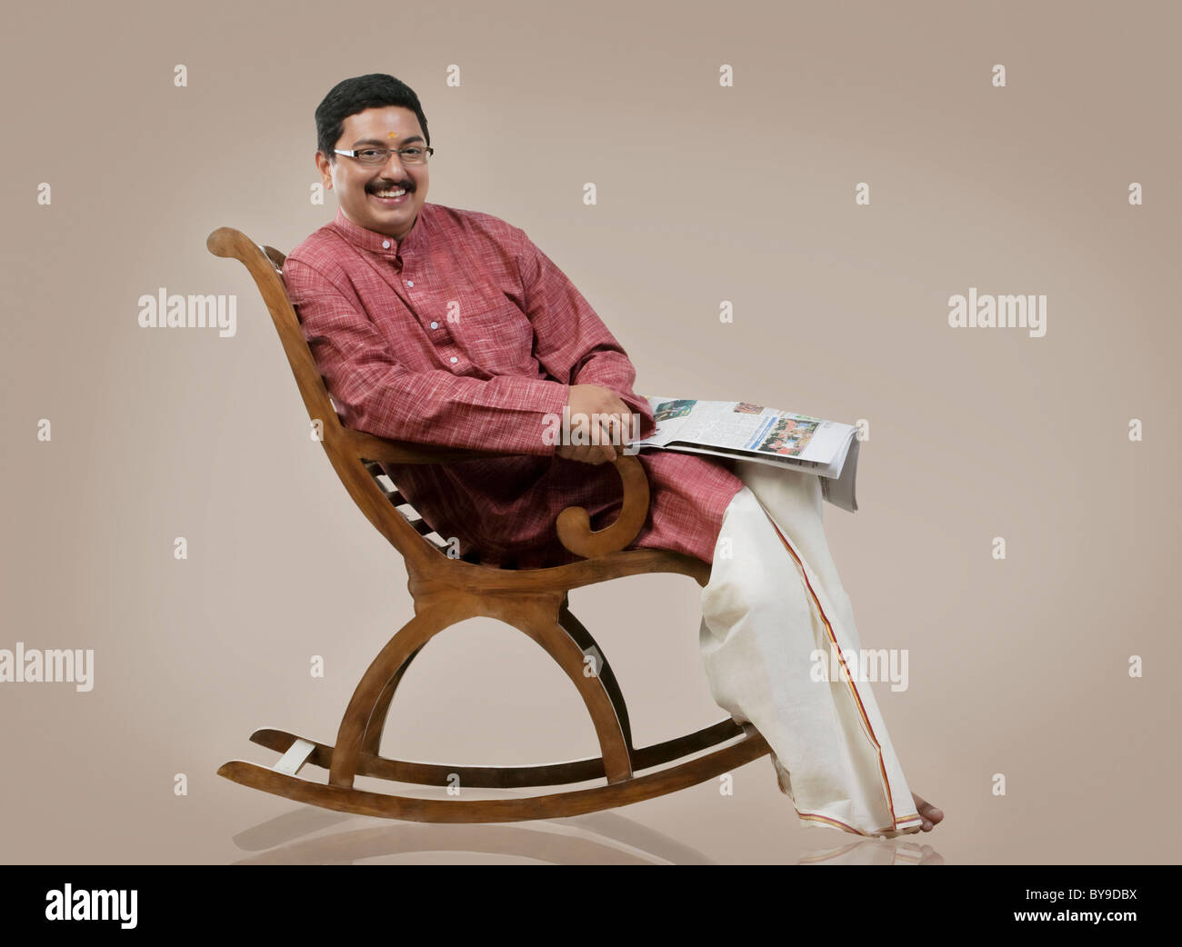 South Indian man sitting on a chair Stock Photo - Alamy