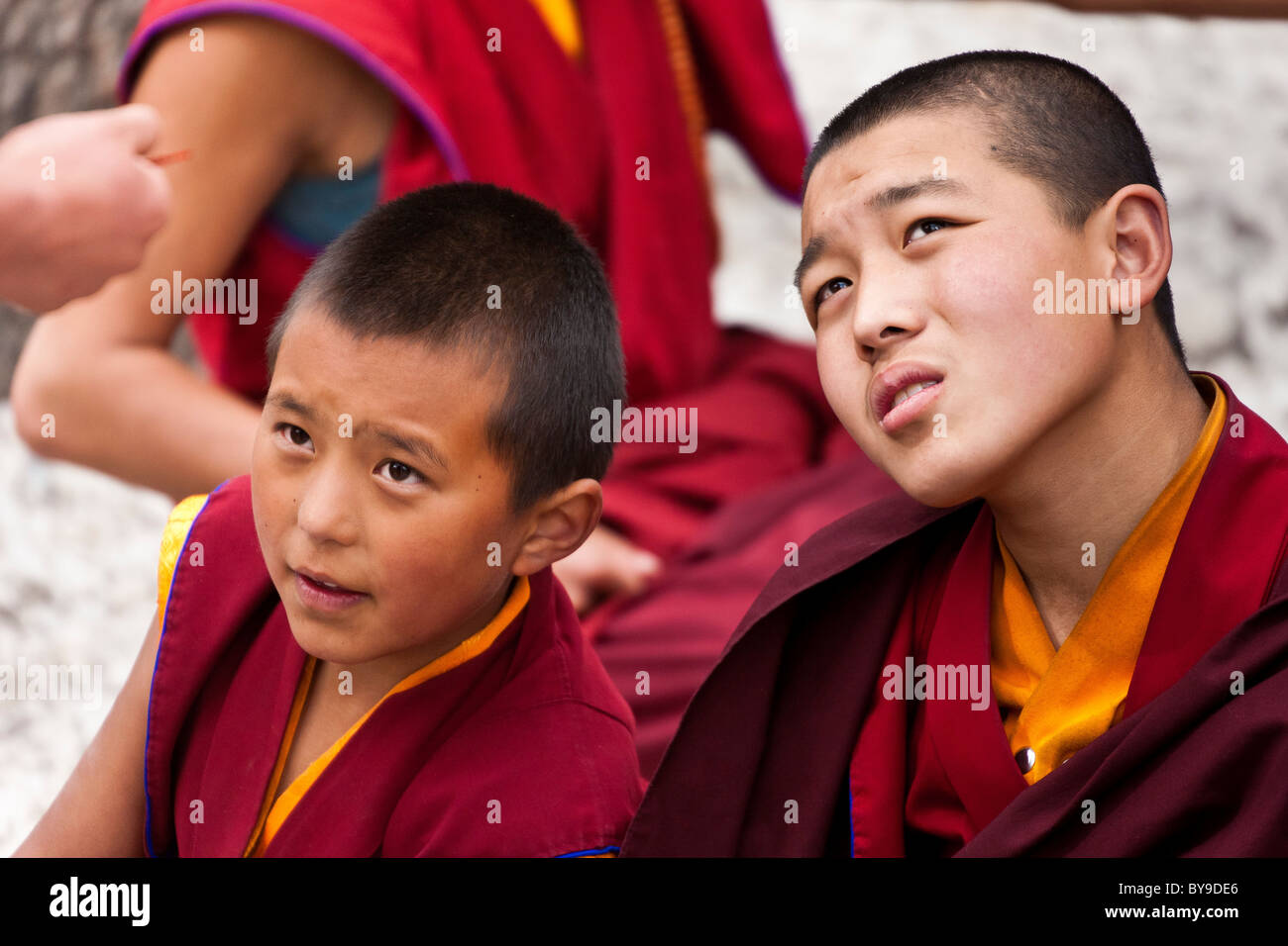 Two young boy monks in the Debating Courtyard at Sera Monastery Lhasa Tibet. JMH4608 Stock Photo