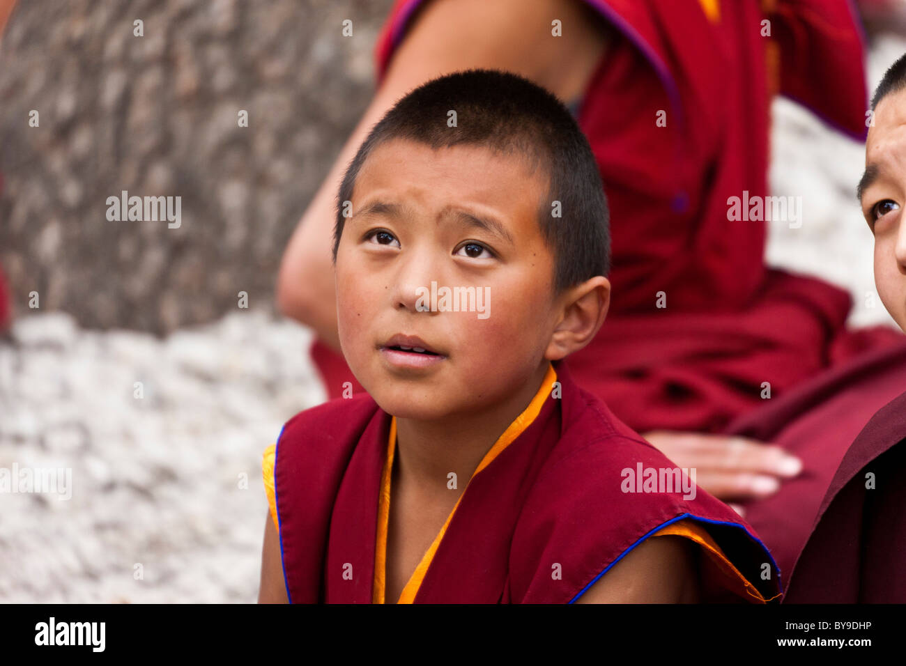 Young boy monk in the Debating Courtyard at Sera Monastery Lhasa Tibet. JMH4609 Stock Photo