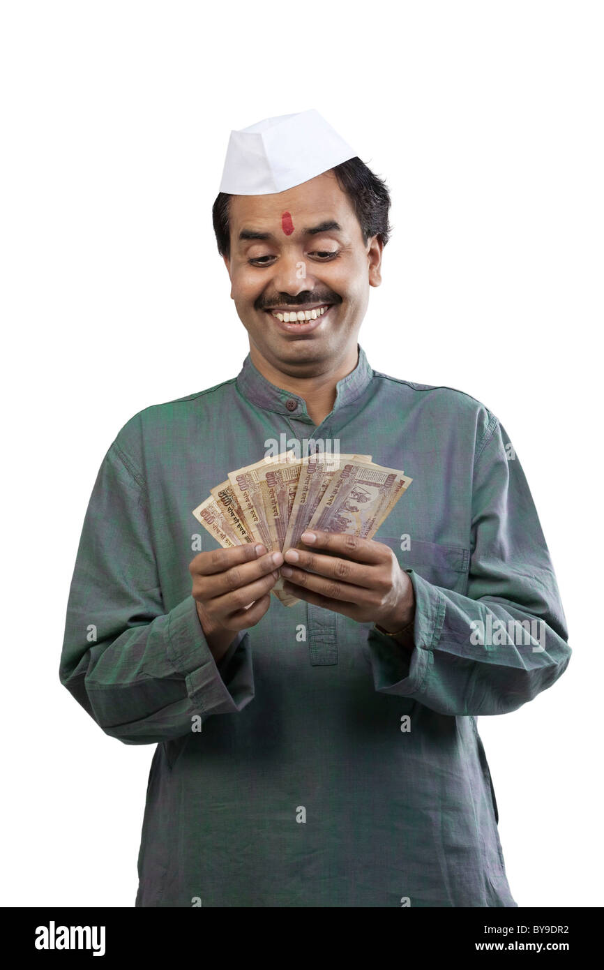 Man looking at Indian currency Stock Photo